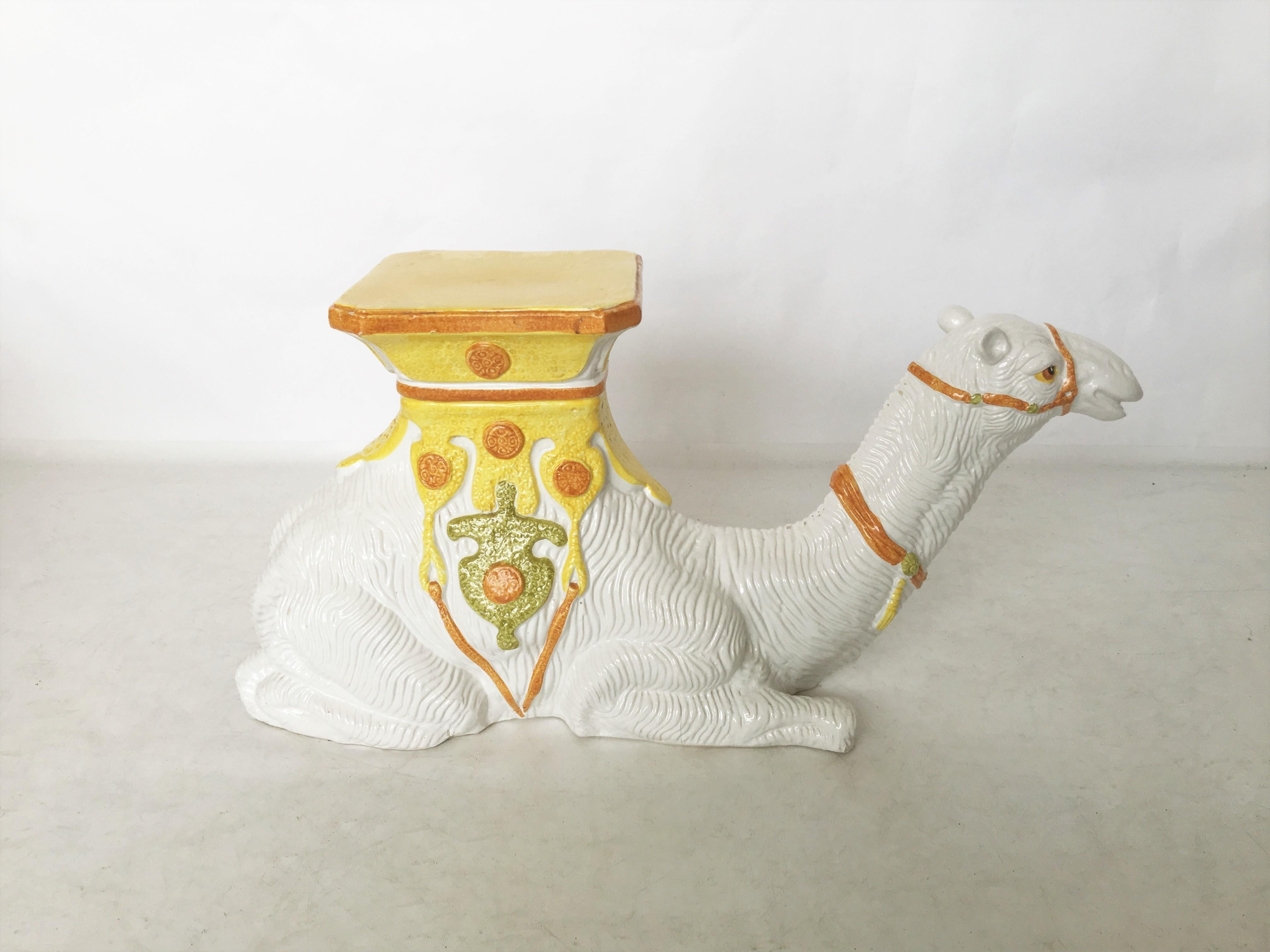 Charming vintage hand painted Italian majolica sitting hump camel side table or garden seat. Between its humps is a decorative saddle with yellow, orange and green details. Works well as a side table or even a plant stand.