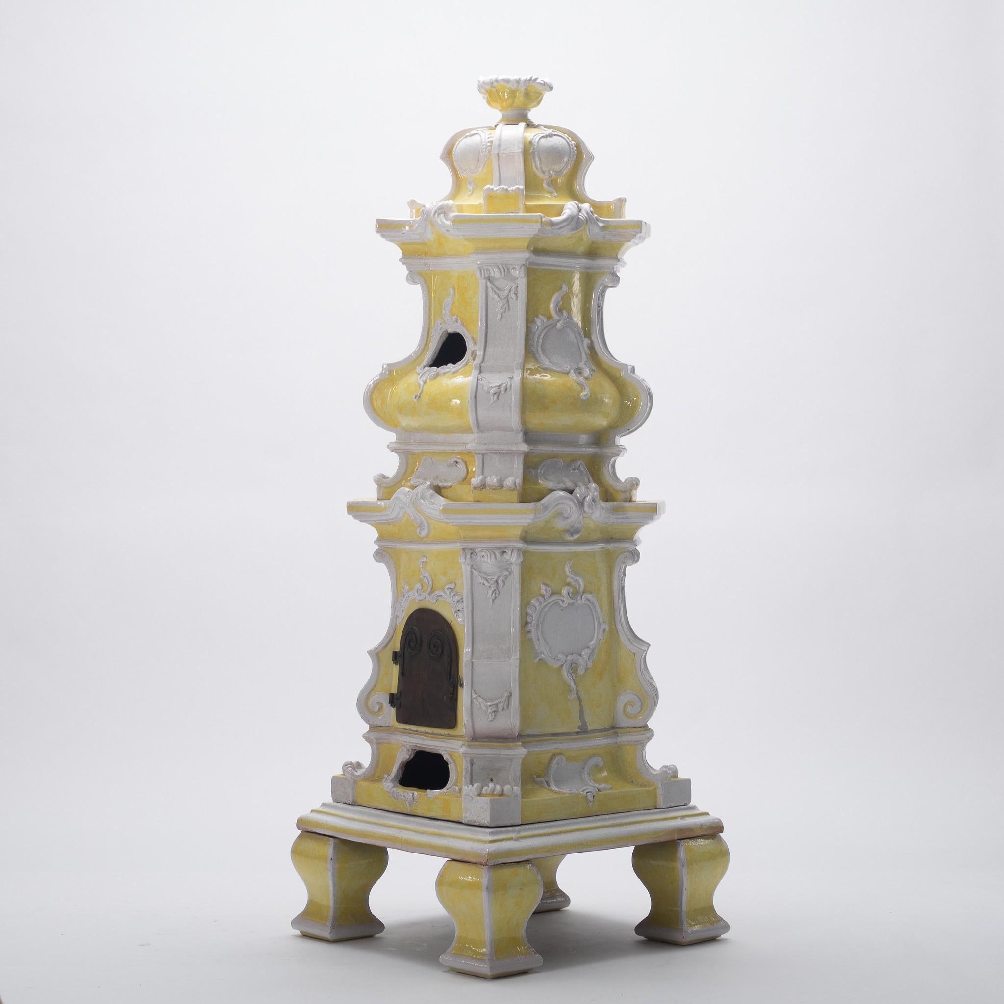 Large Italian handcrafted ceramic stove with yellow and white tin glaze.