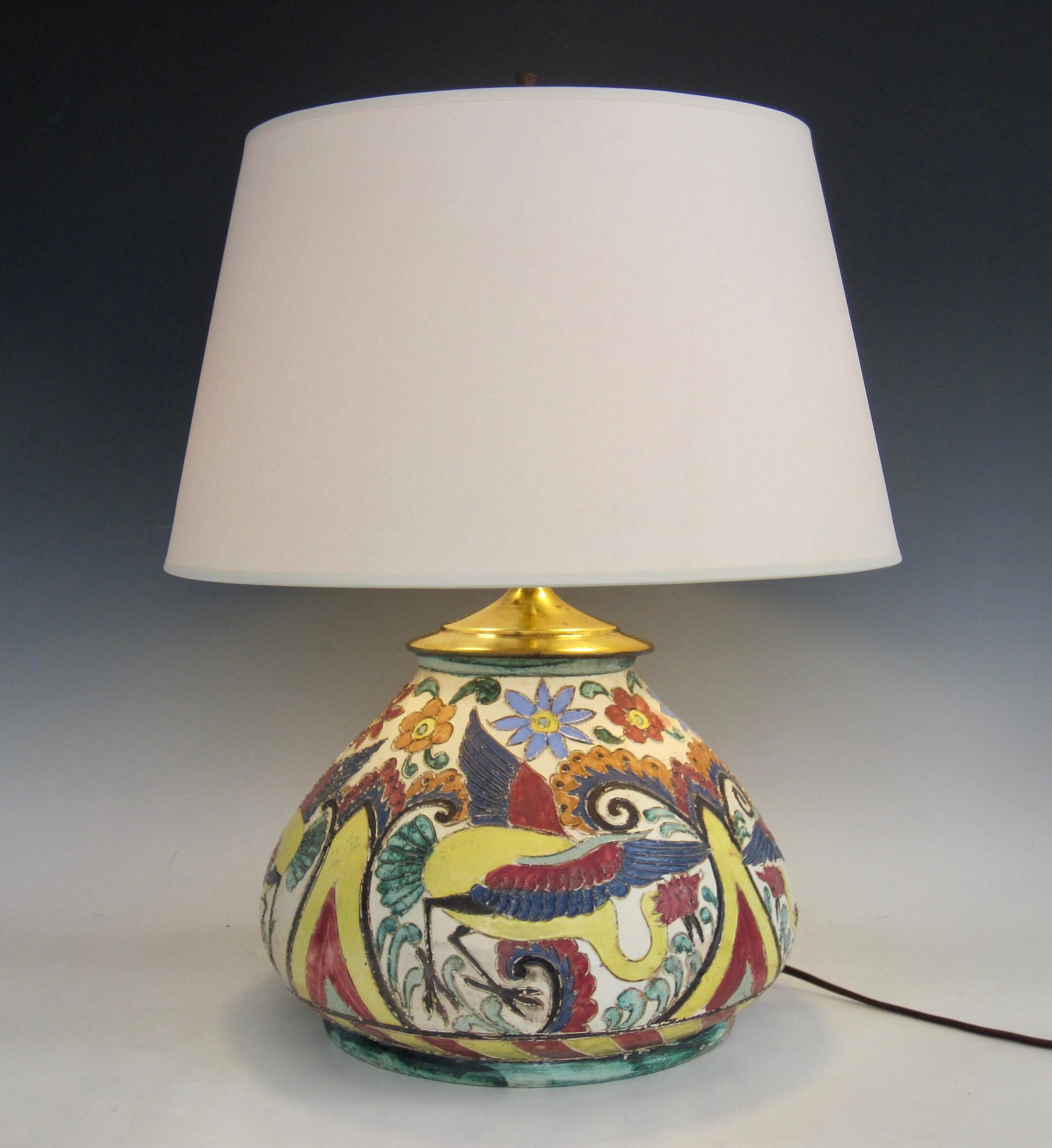 Italian Renaissance Revival majolica table lamp with sgrafitto design of floral and birds of paradise in vibrant colors. This dual socket lamp with original brass hardware has signature on underside that denotes it is Italian made early 20th