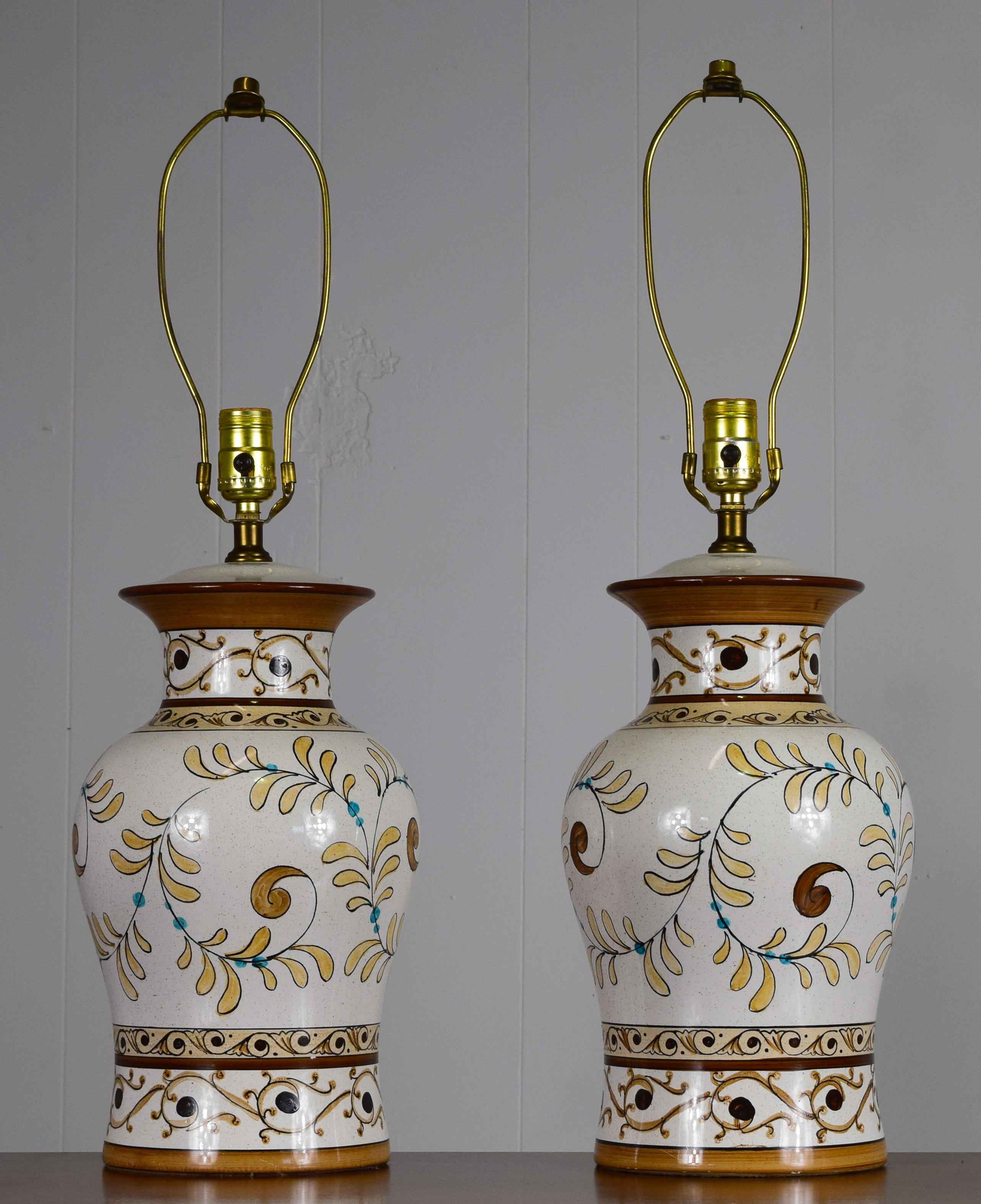 Italian, circa 1960/ Lovely pair of Majolica table lamps shaped like urns produced with ceramic, with sgraffito line work and glaze applied. In perfect condition with 3 way power. Completely unique and handcrafted artisan pieces. Shades are newer,