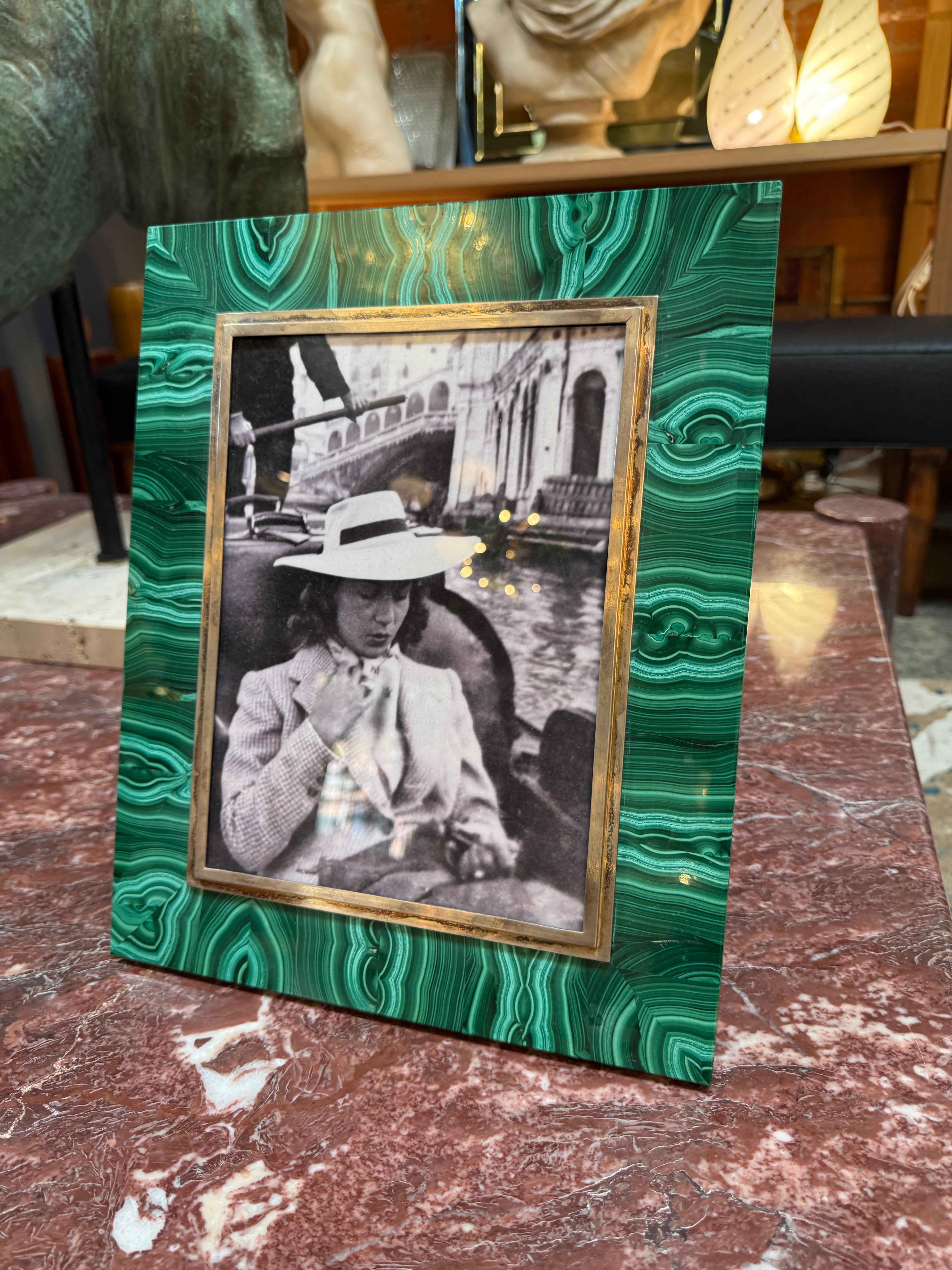 Elegant Italian picture frame from the 1970s, crafted with a polished malachite veneer and accented by a gilt brass border. The vivid green malachite showcases natural banded patterns, giving the frame a jewel-like quality, while the brass trim adds