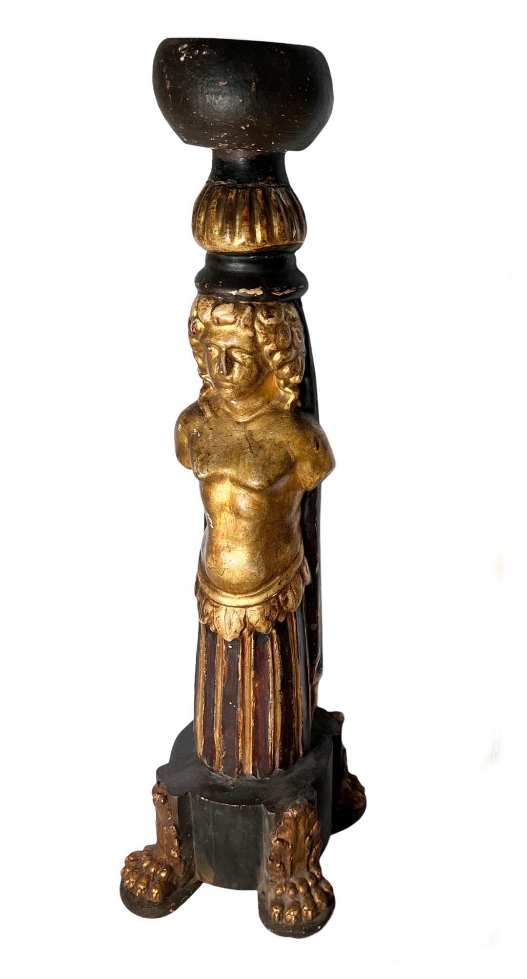 Italian carved wood candlesticks depicting a man and woman. These are very interesting in black and gold with paw feet. Circa 1890, Italy. 