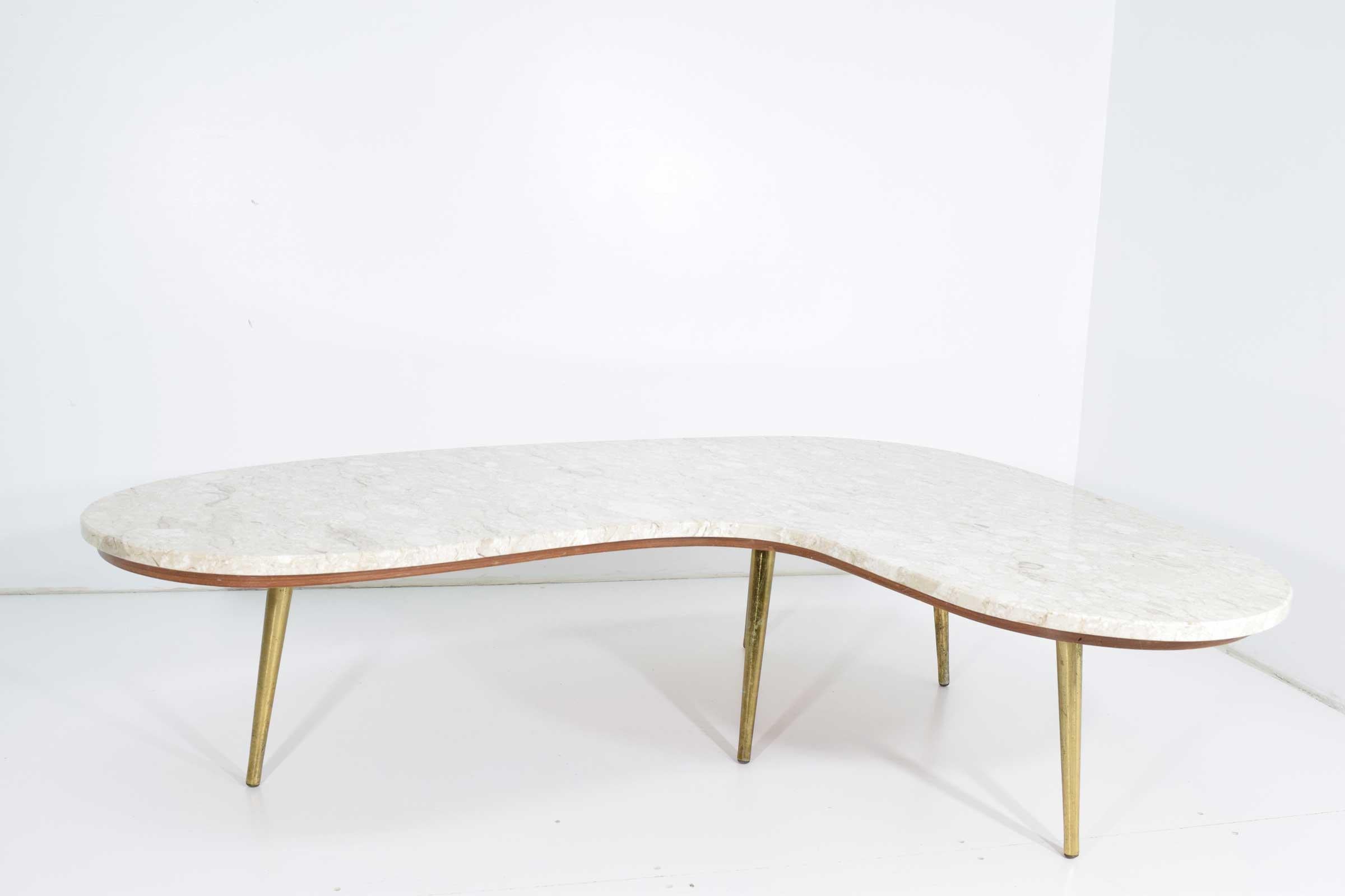 Unique Italian table with brass finish legs and a marble top. Marble rest on a wooden top for added support.