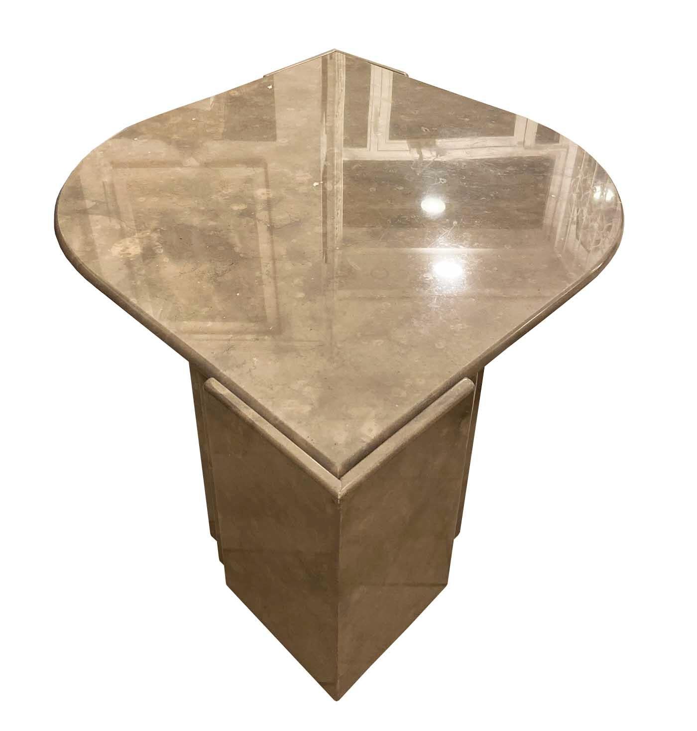 Italian marble 1970s coffee table in good condition.
Beautiful cream, beige and pink marble.
The heavy eye-shaped top rests on two triangles which are build up out of three layers of solid marble.
 
