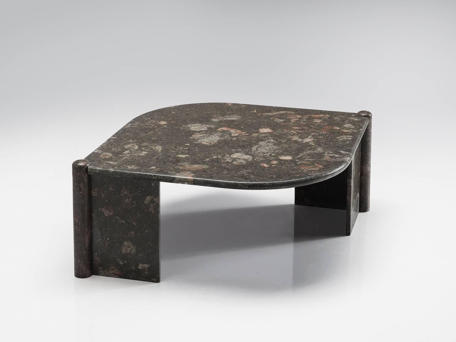 Cocktail table, marble, Italy, 1970s.

This sculptural table has an eye-shaped top and two open triangles that face one another. The circular ends of the base locks the top by means of gravity. The construction is so smoothly designed that