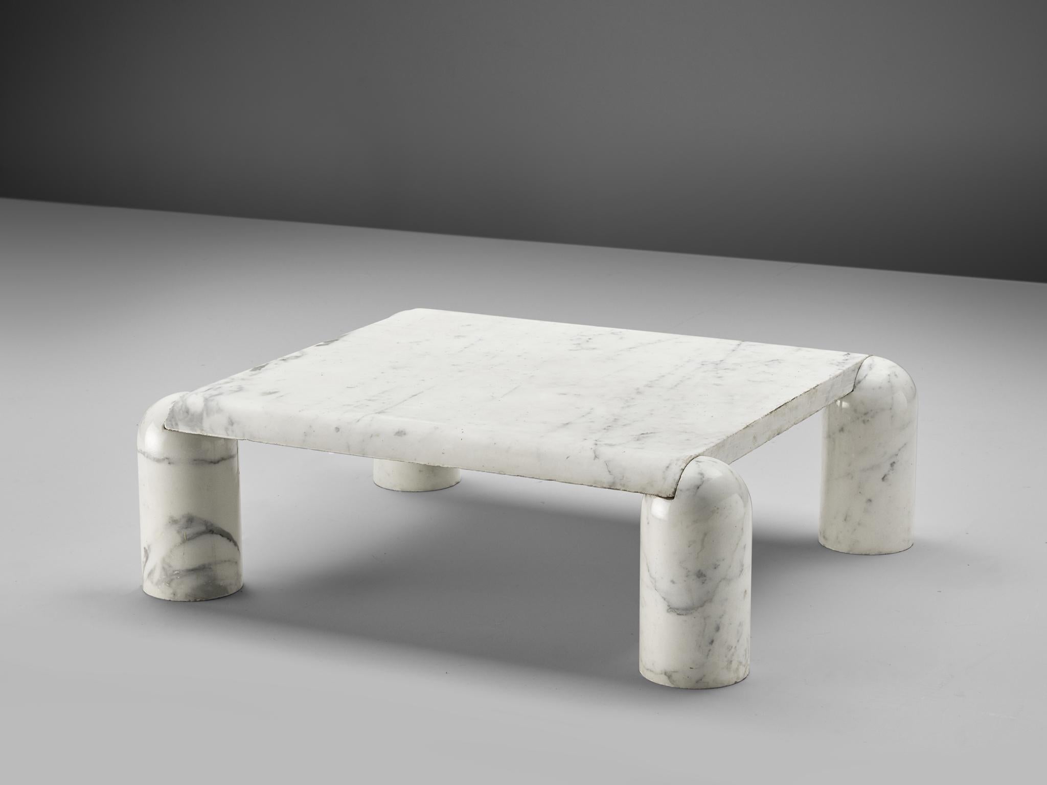Coffee table, marble, Italy, 1970s. 

This sculptural table is a skillful example of postmodern design. The square table features no joints or clamps and is architectural in its structure. The table rests on the four cylinder shaped legs and the