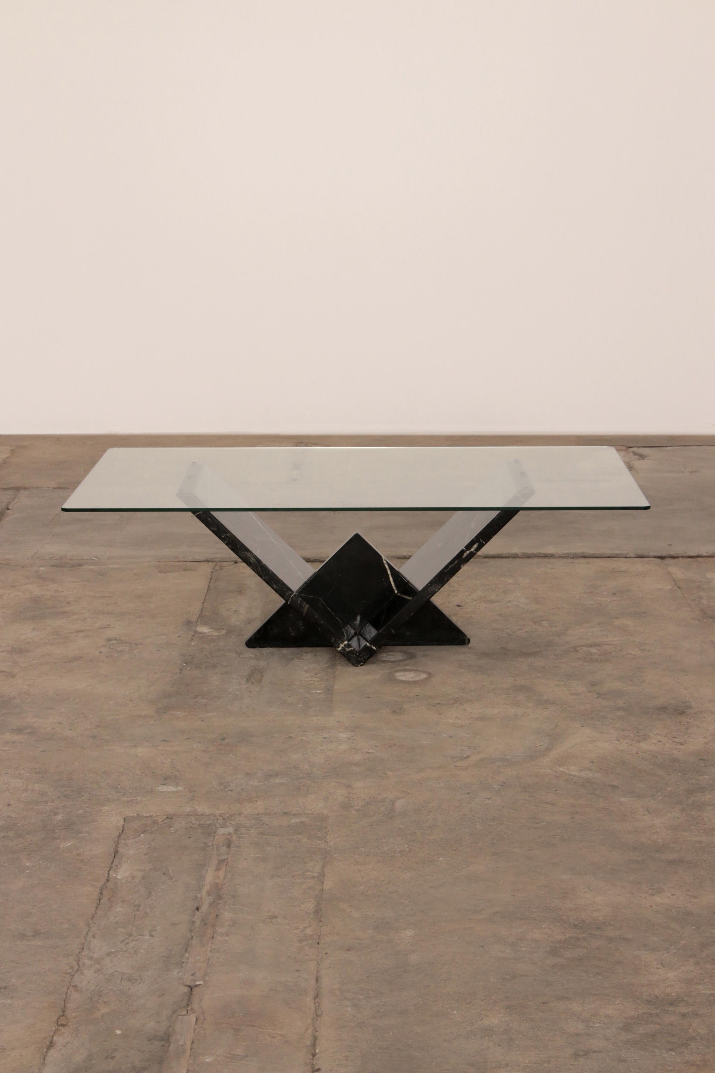 Very nice Italian coffee table handmade from marble, 1970s.

The rectangular top is made of thick glass and the foot is made of very beautiful black mixed marble. The fantastic marble has a very beautiful pattern of different colors.

