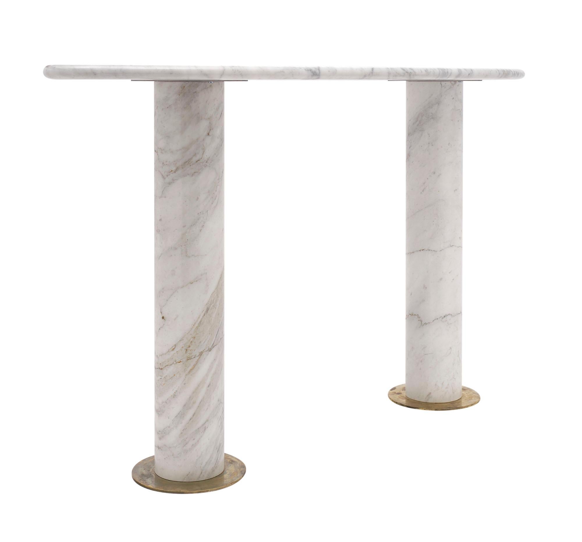 Console from Italy made of veined Carrara marble. The oval slab top fits securely on two marble pedestals and each has a brass base.