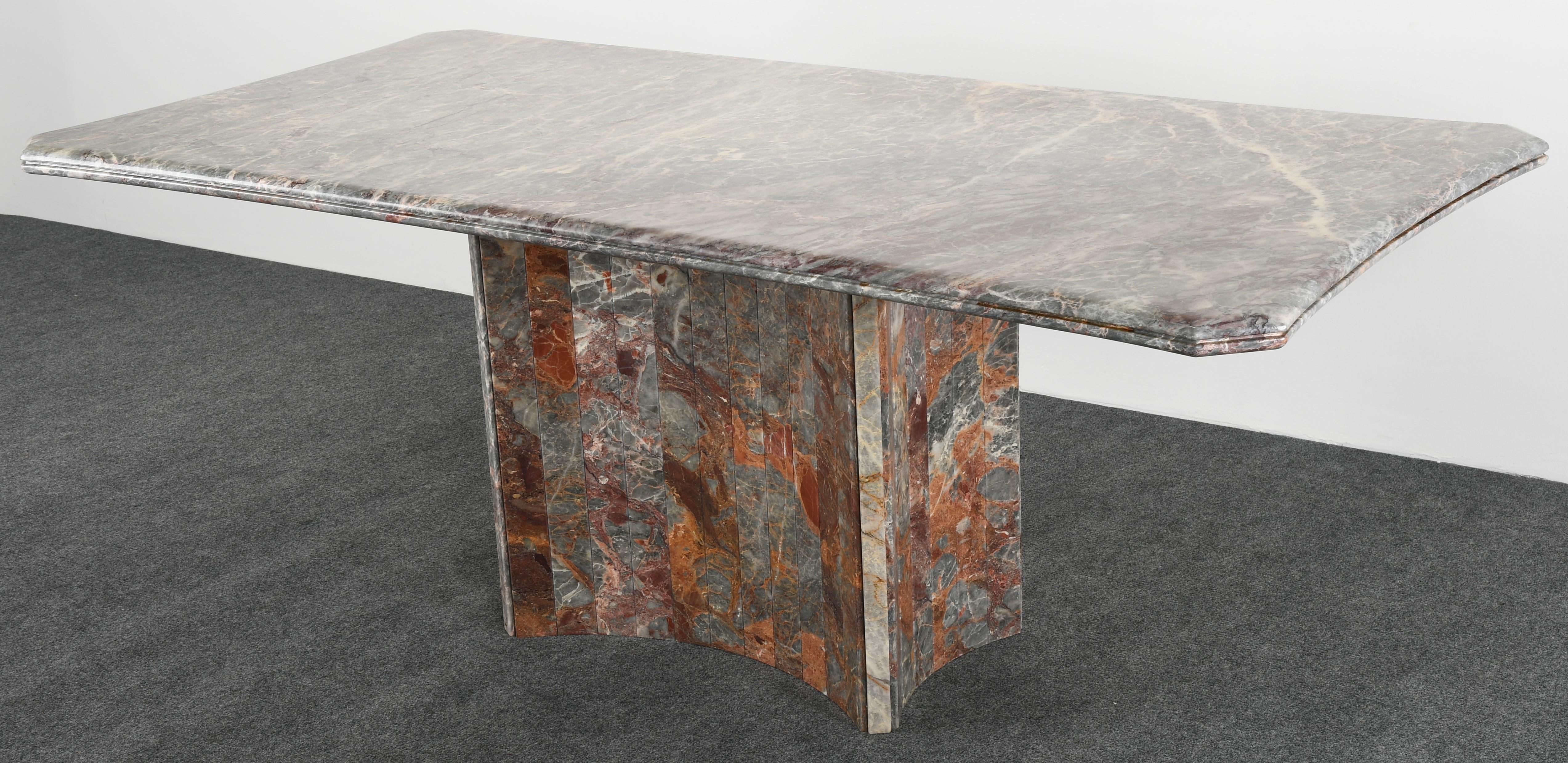 A distinctive Jasper green and Rouge Italian marble dining table by Maurice Villency. The top is solid marble with angled corners and beveled detail. The base is alternating with smaller marble panels. Labeled 