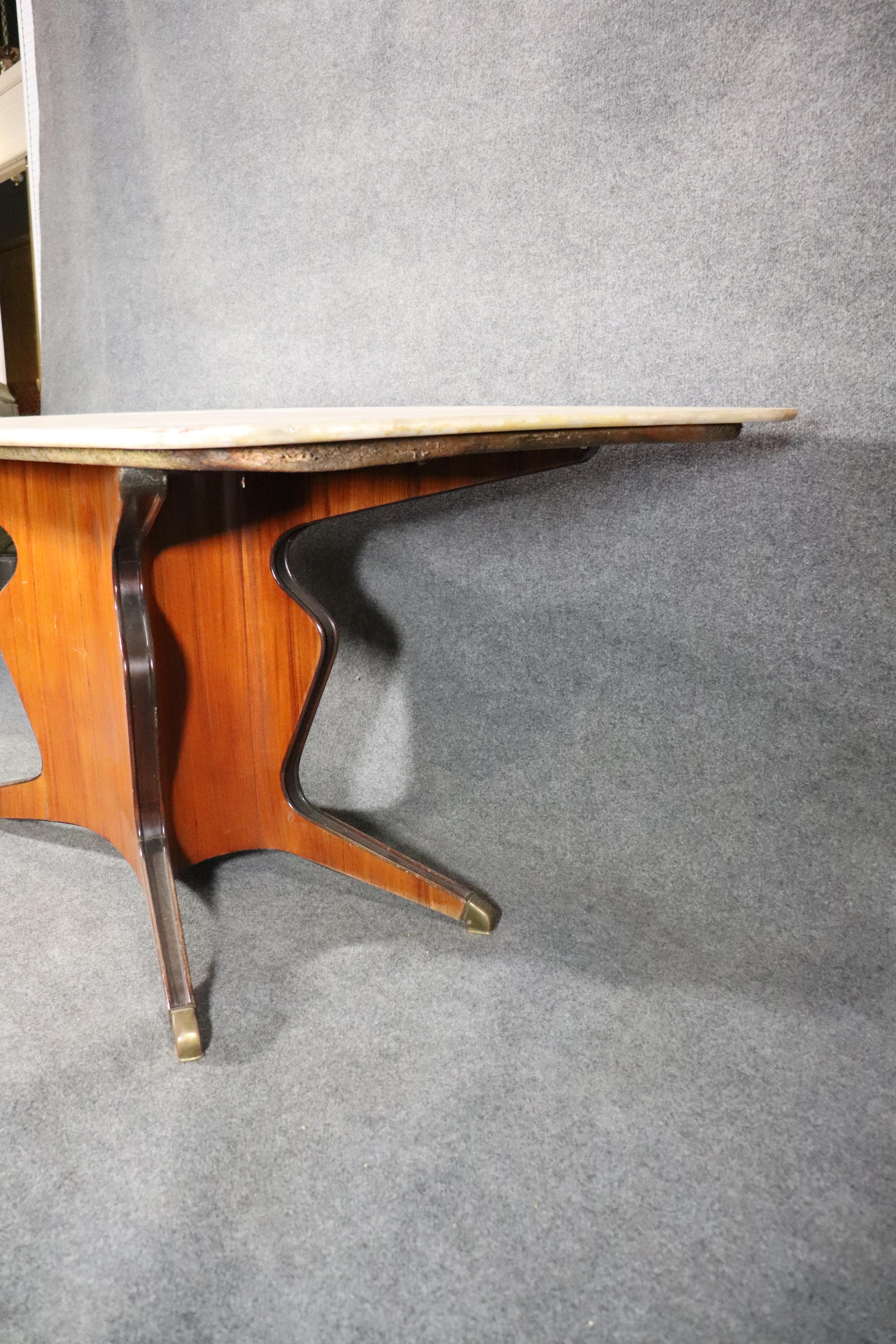 Mid-century Italian dining table with large marble top. Sculpted wood base with brass feet.
Please confirm location.