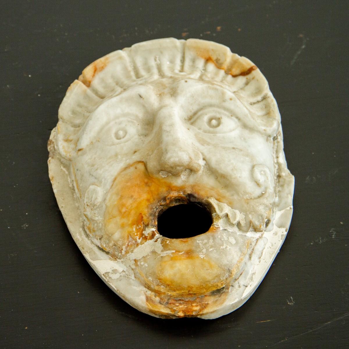 An Italian, white marble fountain mask depicting a moustached male face. These fountain masks were designed to be on a wall or pedestal over a basin with the water flowing through the mouth, circa 1840.
 