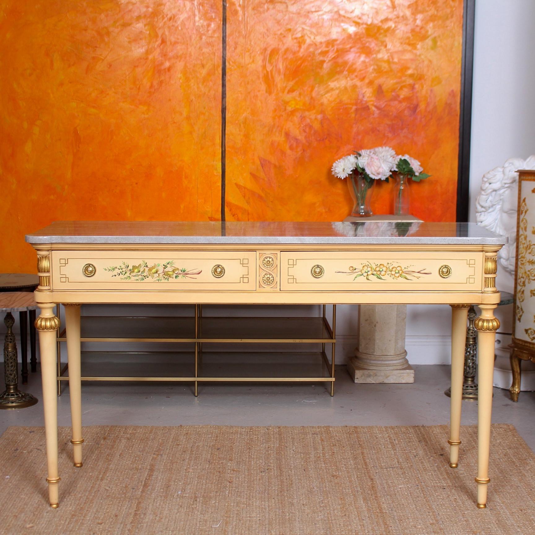 A fine quality hand painted marble topped Italian sideboard / console table originally retailed by Maple & Co.

The excellent grey marble top with rounded corners to match the shaped of the table with hand painted gilt borders, flowers. Raised on