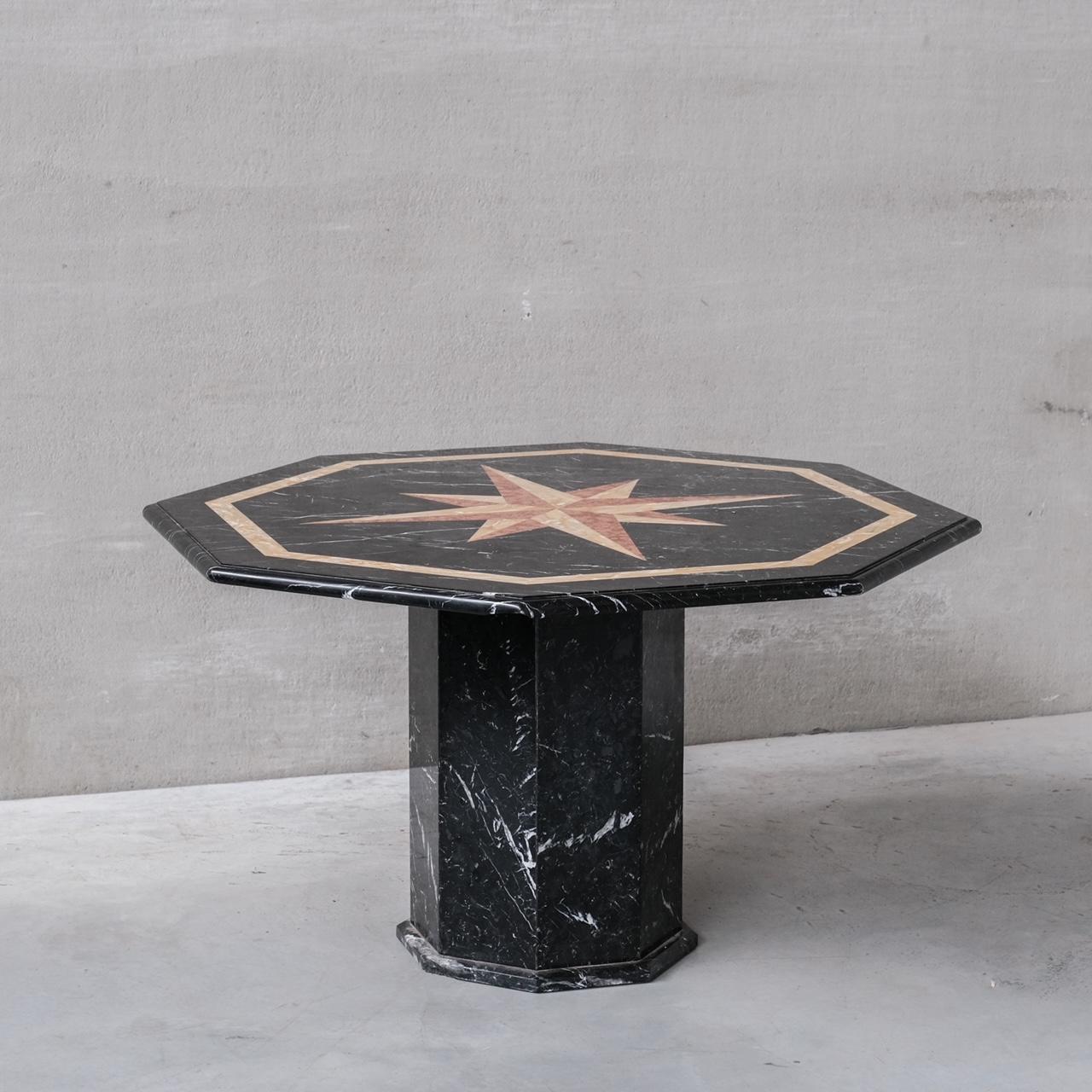 A marble hexagonal dining table. 

Italy, circa 1960s. 

A variety of marble specimens used in the top. 

The top generally is in good condition, however there is a chip to at least one side which is felt on the underside. There is also a chip