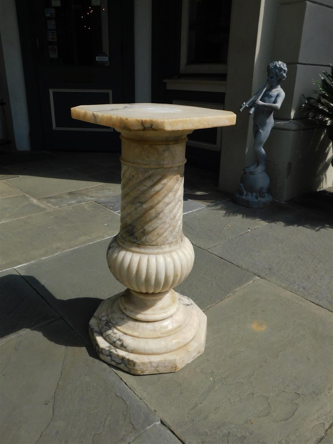 Italian marble carved pedestal with a central fluted and spiral ringed column, squared top with flanking canted corners, and resting on an octagonal base, early 19th century.