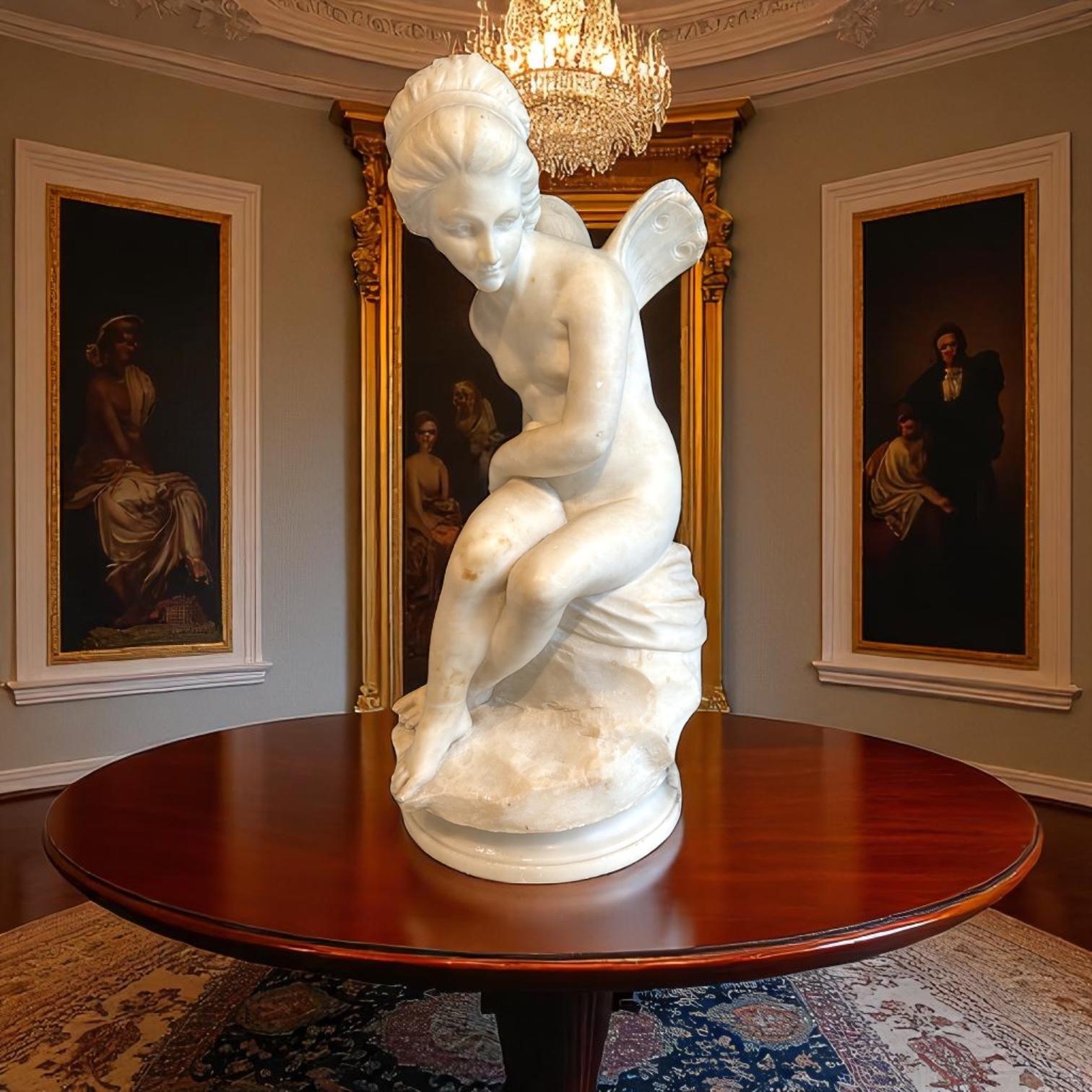 This 19th-century Italian marble sculpture depicts a seated winged figure—likely Psyche—resting on a draped rock. The figure is gracefully posed, with a gentle turn of the head and a soft, contemplative expression.

Executed in white marble with