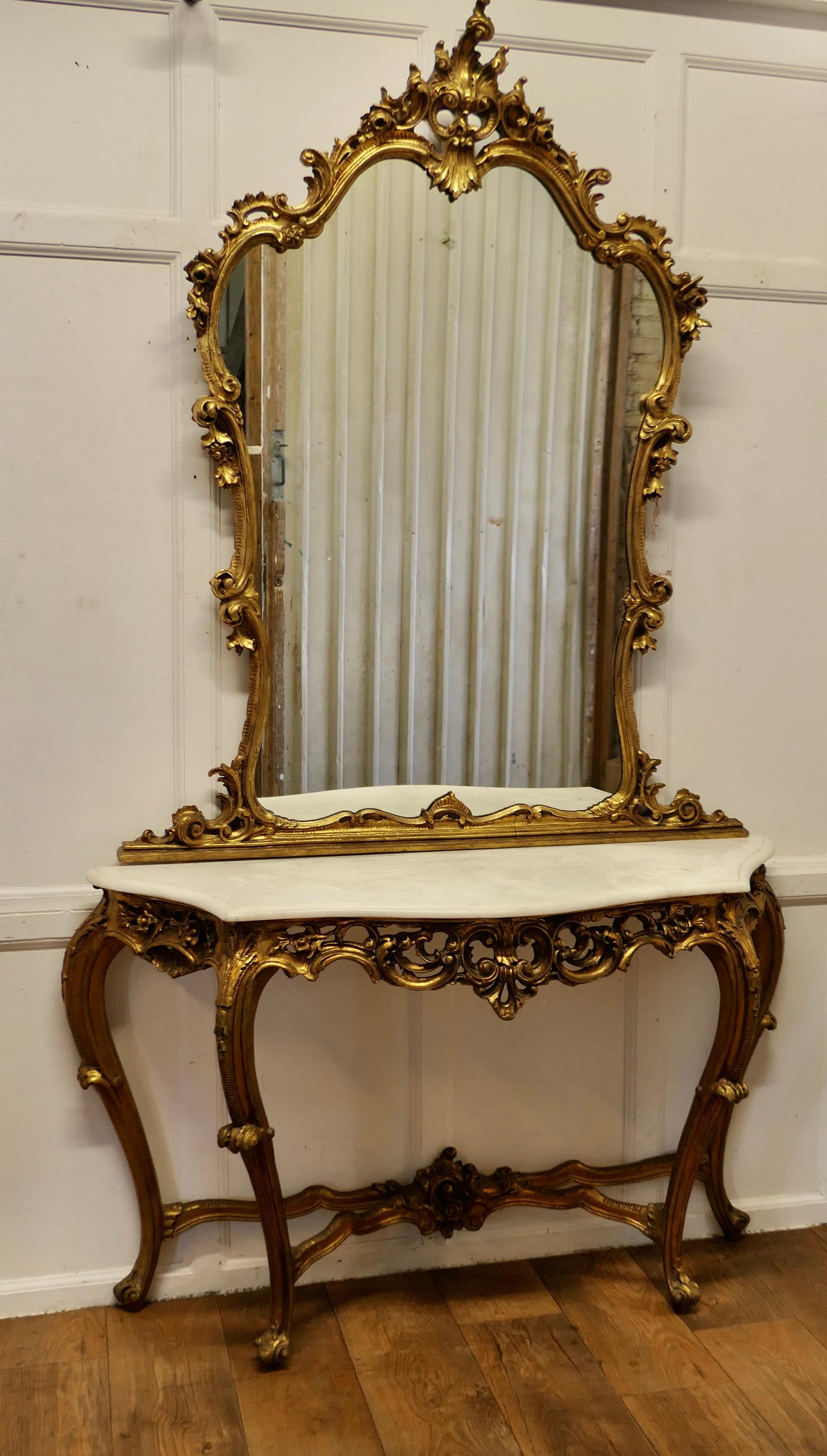 Italian Marble Top Console Table and Mirror Set

A very rare set, complete and still together, the set dates from the early part of the 20th Century
The Table and Mirror are richly carved in the Louis XV Style, the table has its original marble top,