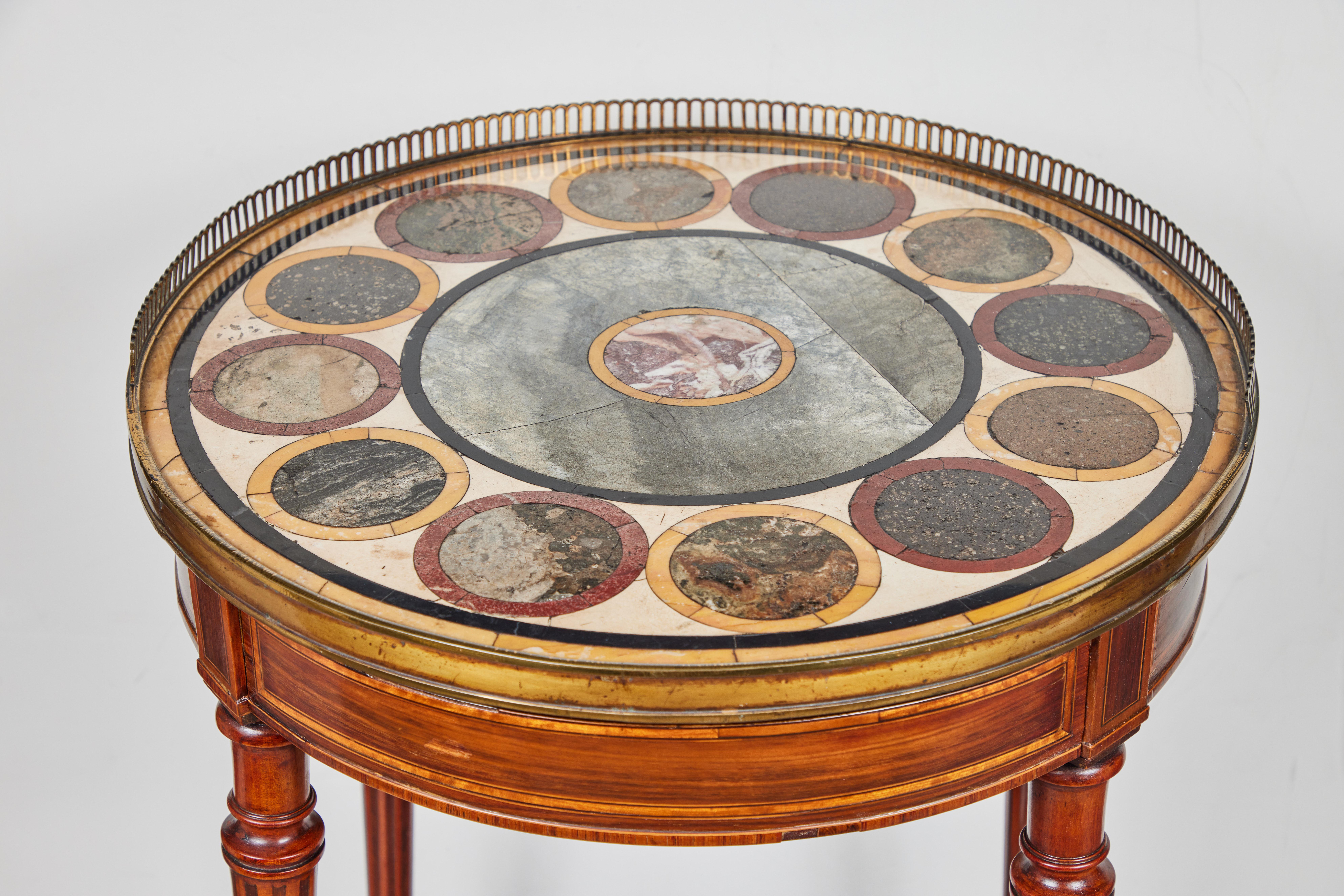 A fabulous, round, single drawer, Italian occasional table on gilt bronze, wheeled feet. The 19th c. inlaid, walnut base is surmounted by a wonderful, 18th c., marble top surrounded by a half-moon, pierced, gilt bronze parlor.