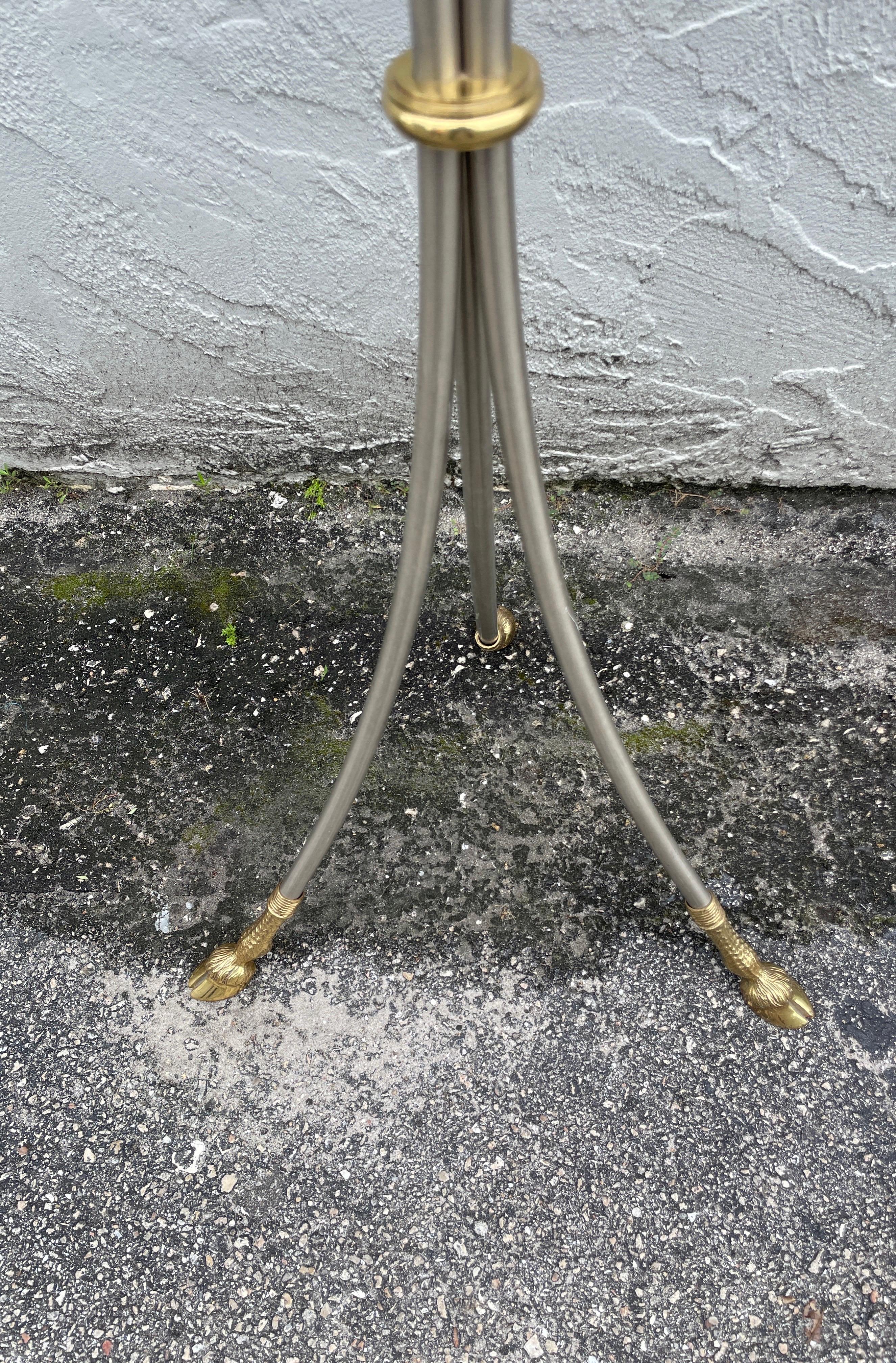 Neoclassical style steel and brass pedestal with marble top. Tripod form with hoof feet and three brass rings. Legs at bottom are 16