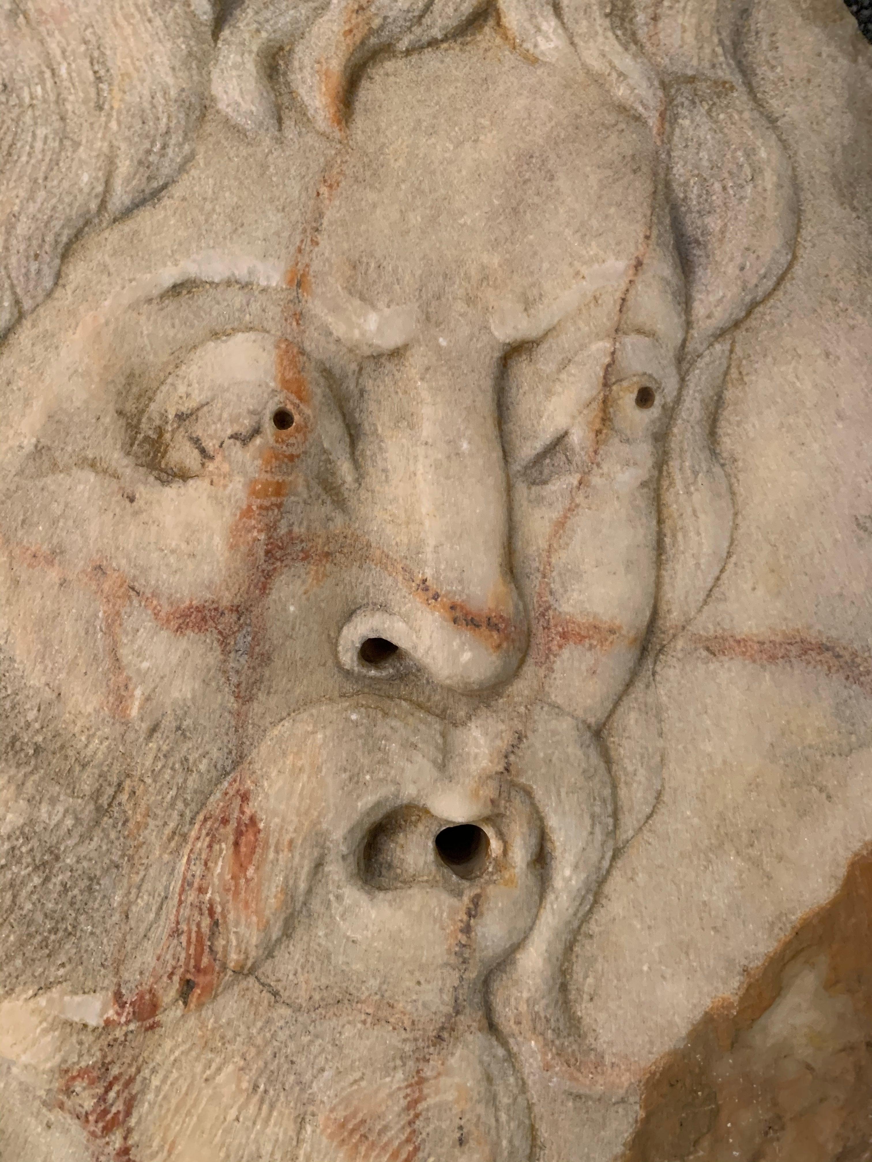 An early 19th century Italian marble wall fountain. A beautiful antique marble fragment sculpted as a bas-relief portrait of a Classic Roman head.