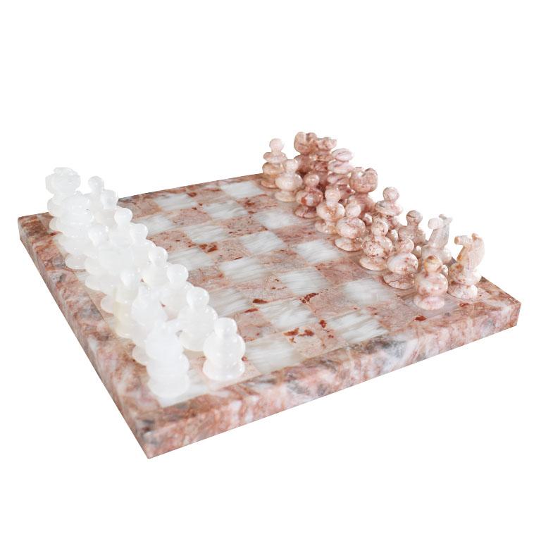 A complete pink Italian marble and white quartz stone chess set. This board includes all of the original game pieces. Half of which are in pink, and the other in white quartz. The board is square and made up of checkered squares in a rose pink and