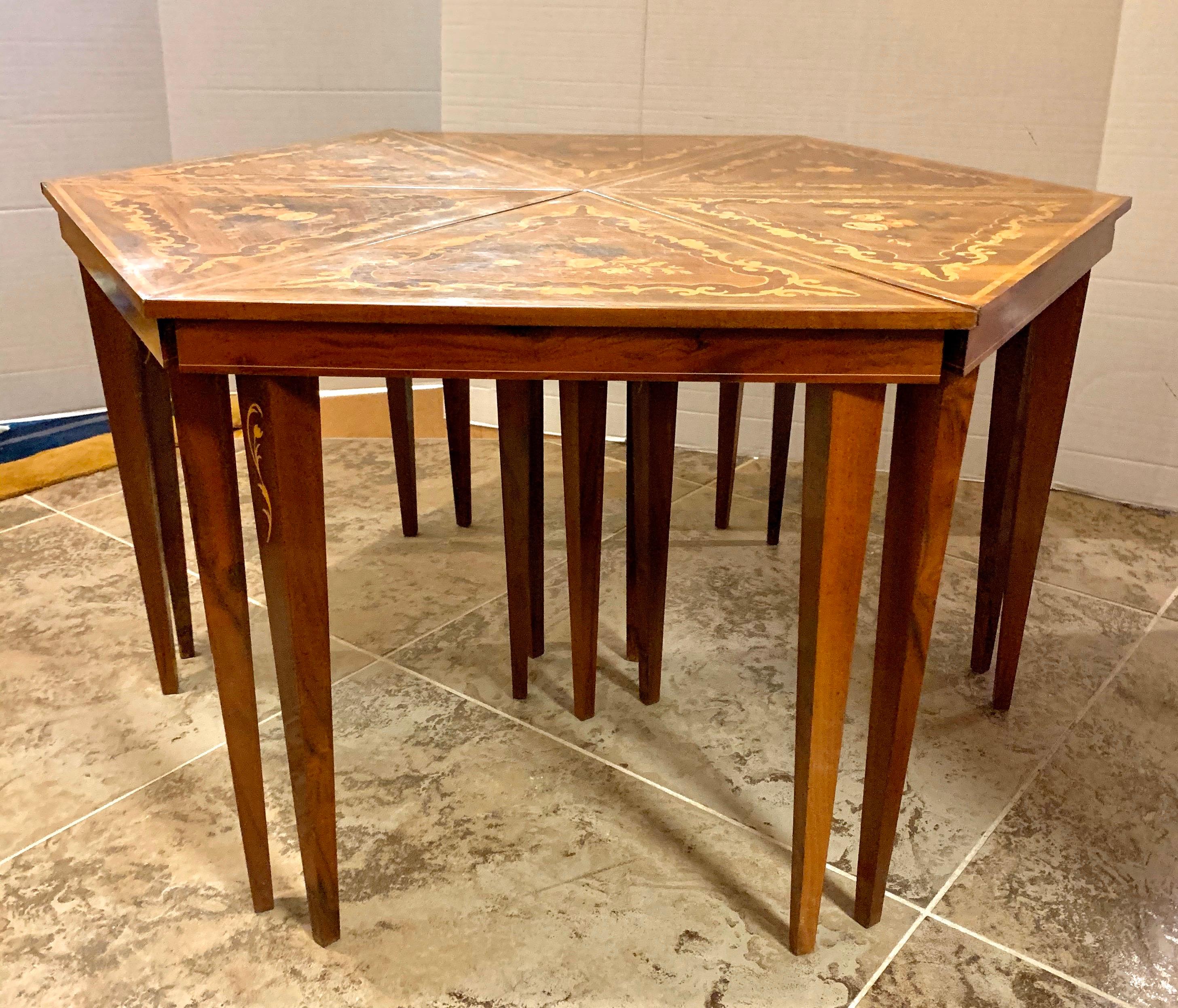 Italian marquetry hexagon shaped coffee table is made up of six separate triangular shaped tables. Each features intricate marquetry scroll work and a center floral motif. They can stand alone as side tables or put together as one coffee table. Made