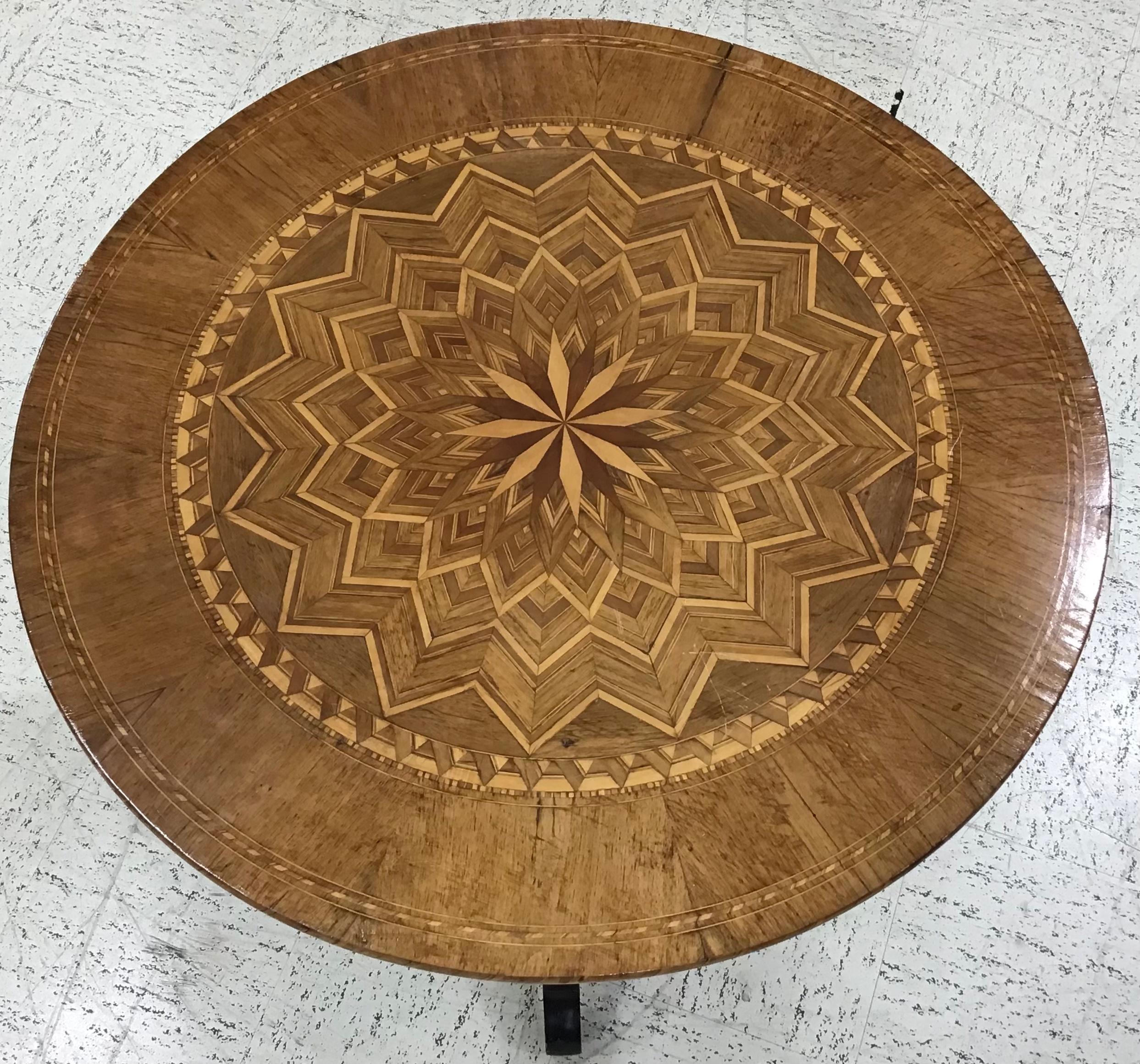 19th century Italian side or center table with elaborate marquetry top inlaid with walnut and various fruit woods, typical of Sorrento, Italy. The tripod base also inlaid with geometric patterns.