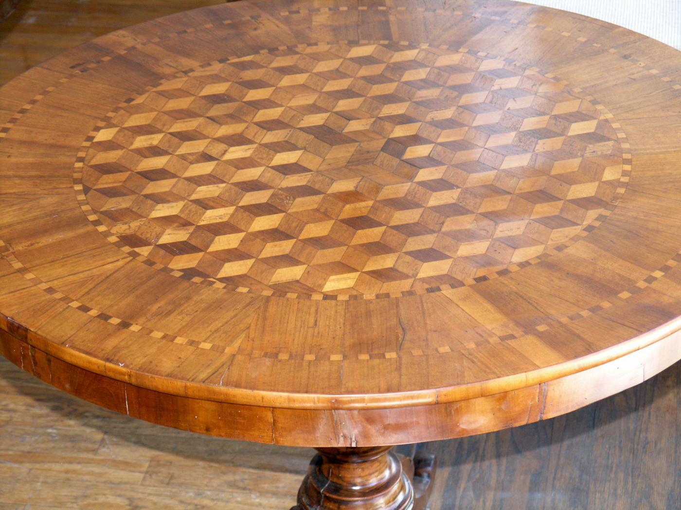 Circular marquetry inlaid top raised on a baluster turned support resting on a tripartite base with slightly scrolled feet.