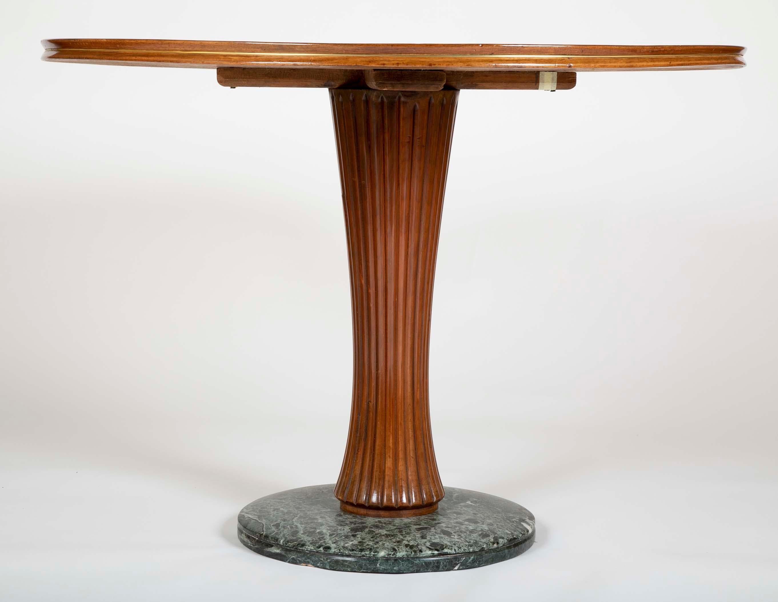 A beautiful Italian marquetry top table with green marble base and fluted column in the manner of Paolo Buffa. Subtle marquetry top in the form of a starburst with a blond wood star in the middle.