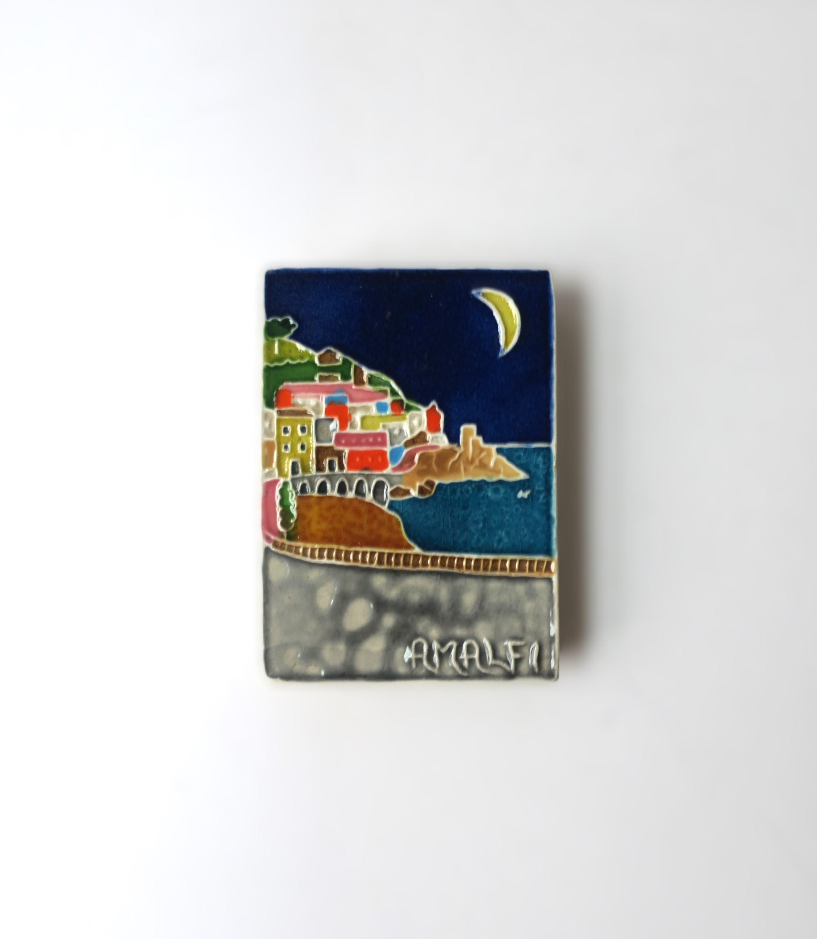 An Italian matchbox case with ceramic 'Amalfi' coast decorative tile, circa mid-20th century, Italy. A beautiful, colorful Italian ceramic tile with Amalfi coast scene holding four (4) matchboxes with striker sides. Strike-up your best candles, or