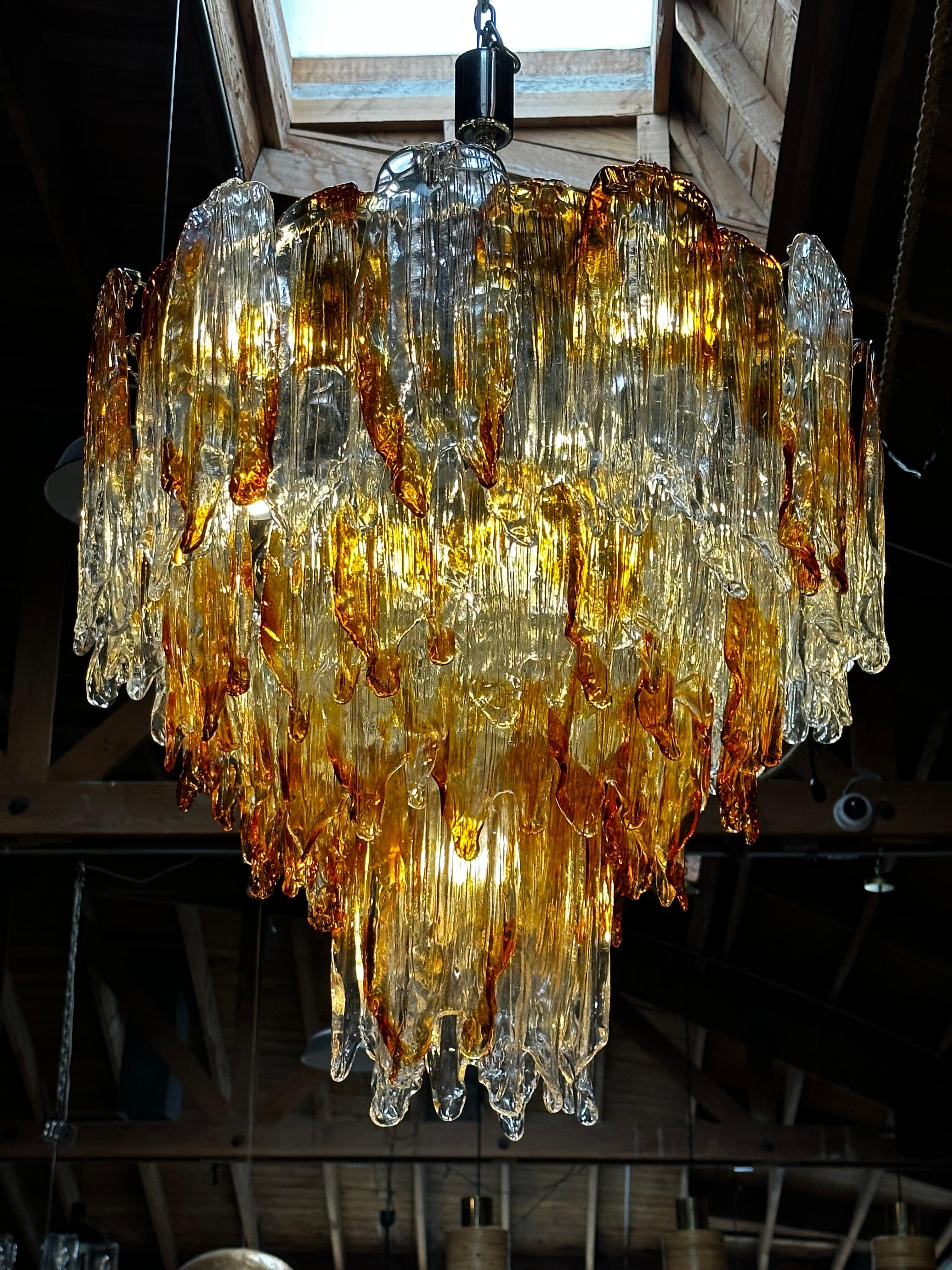 Italian chandelier shown with amber and clear Murano glasses hand blown to form beautiful dangling stalactite shaped glasses, mounted on chrome finish frame, 1960s
 