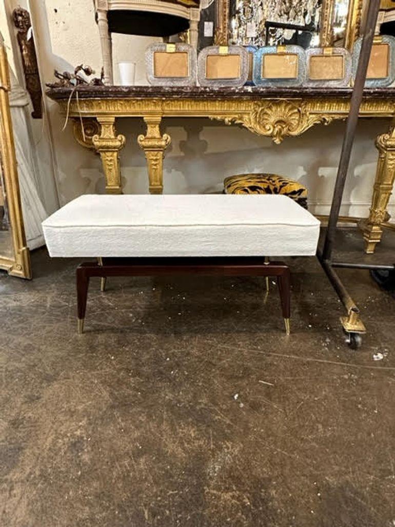 Nice Italian Mid-Century Modern style mahogany and brass bench. Upholstered in a creme colored fabric. Perfect for a modern home.