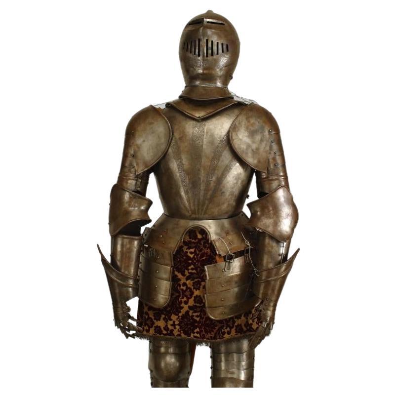 Italian Medieval / Renaissance-style metal life size suit of armor with etched sunburst breast plate on a square wooden base.

Condition: (Base is 20 inches w x 24 inches d x 10 inches h.)