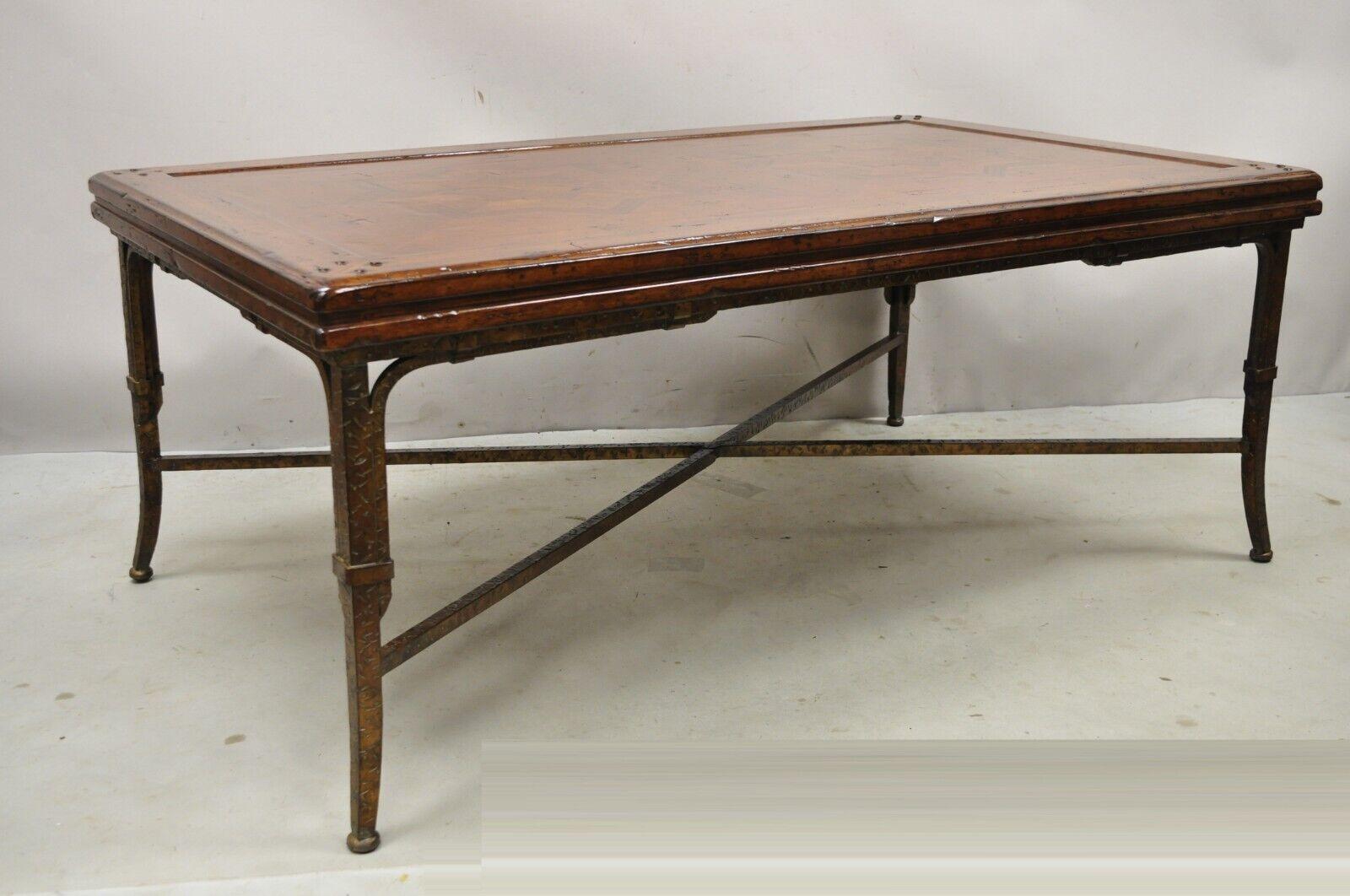 Italian Mediterranean Style Marquetry Star Inlay Iron Base Maitland Smith Style Coffee Table. Item features heavy forged iron stretcher base, solid wood marquetry inlay star form top, distressed finish, very nice item, quality craftsmanship, great