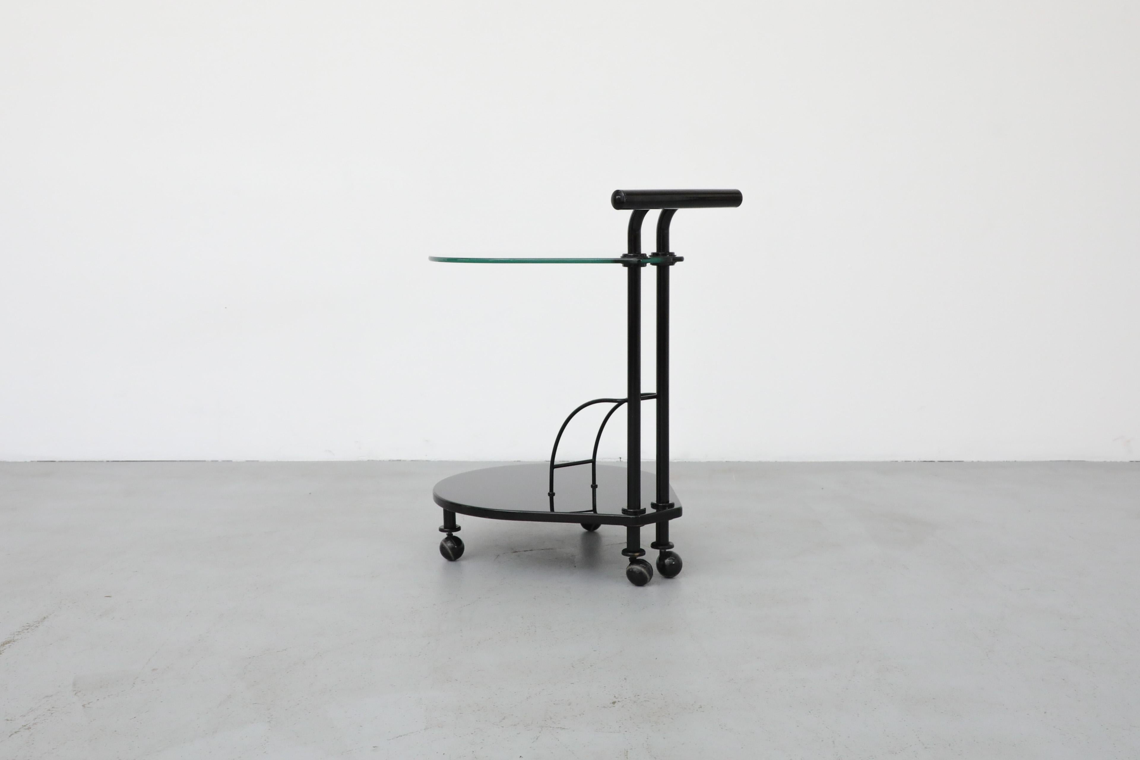 Late 20th Century Italian Memphis Style Two Tiered Rolling Bar Cart with Black Frame and Glass Top For Sale