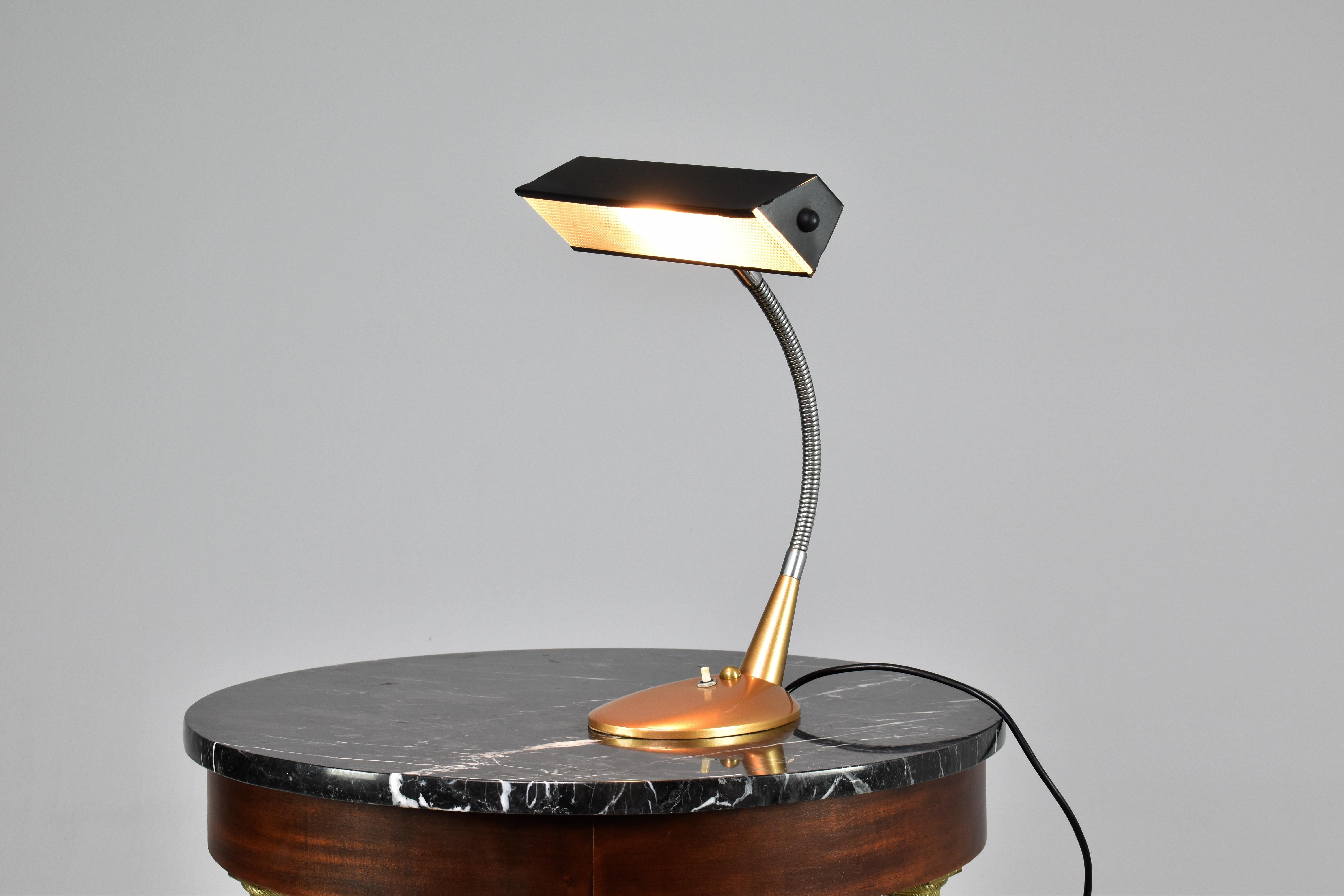 An Italian 1950s vintage desk lamp with an articulating gooseneck arm and diffuser shade. The glass diffuser helps to soften and distribute the light evenly, making these lamps particularly useful for tasks that require focused lighting, such as