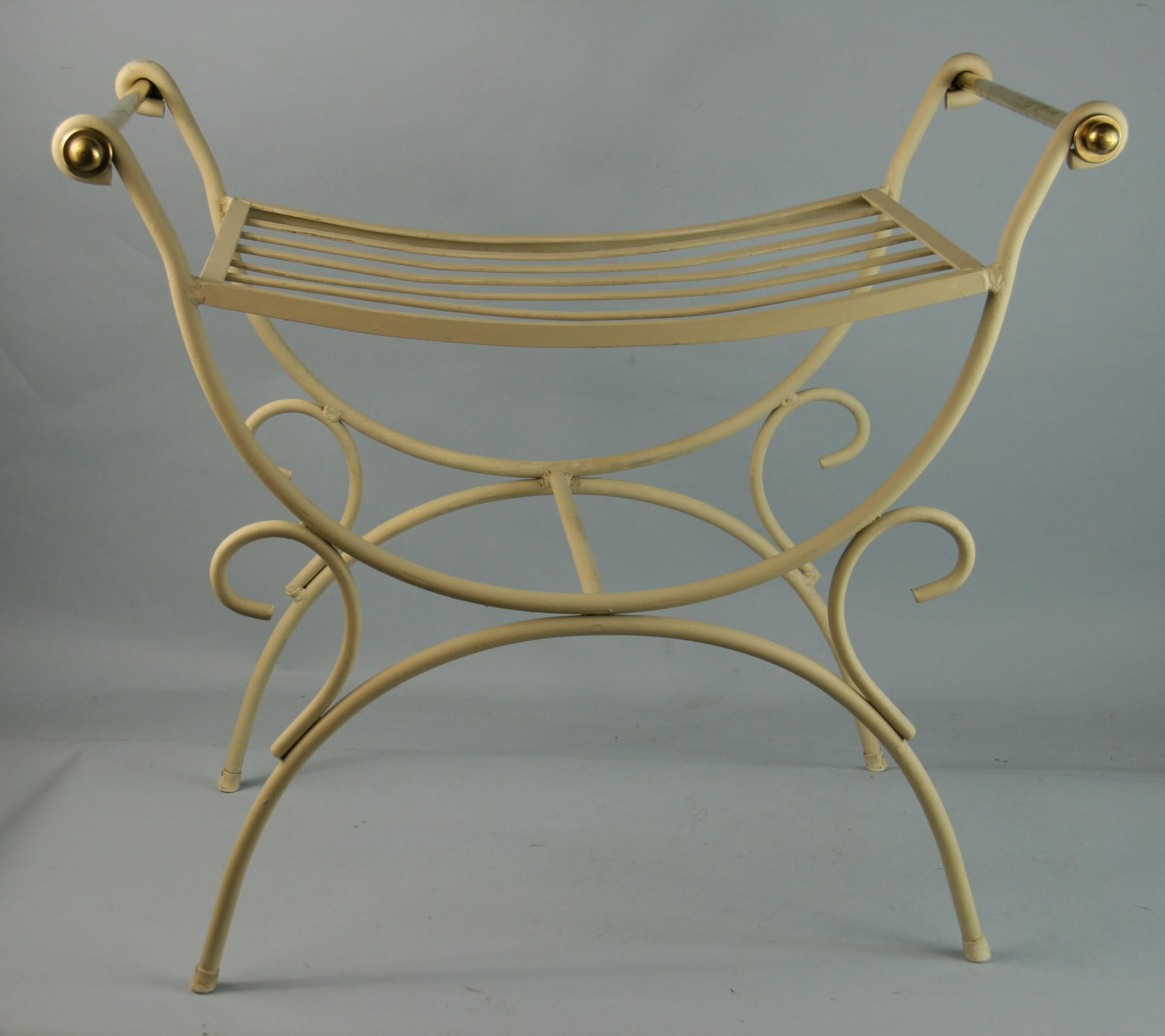 Italian metal bench with curved seat and brass handles.