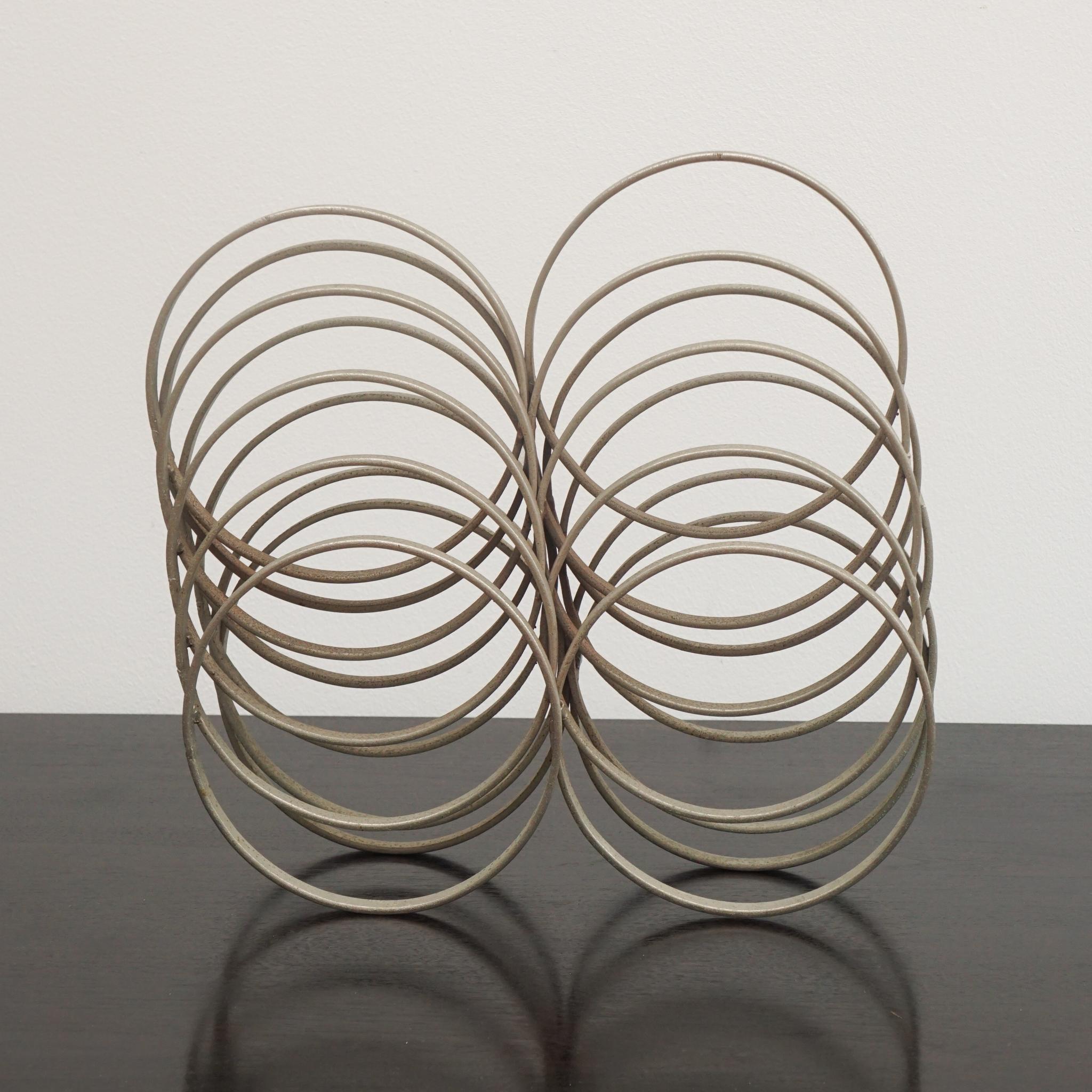 Metal rings were used to create the unusual stepped sculpture, shown here, from Italy c. 1970s.   Arranged in ascending and descending order, the coils are soldered in place to create a free-standing vertical or horizontal work of art.  