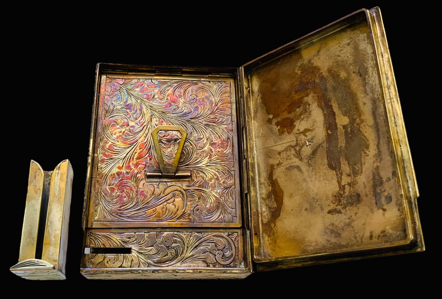 This is an Italian metal vermeil square compact with a hand painted pastoral scene of a romantic couple. It depicts a sheperdess resting in the lap of a shepherd in a garden with a fountain behind them. There are also some sheeps laying down in the