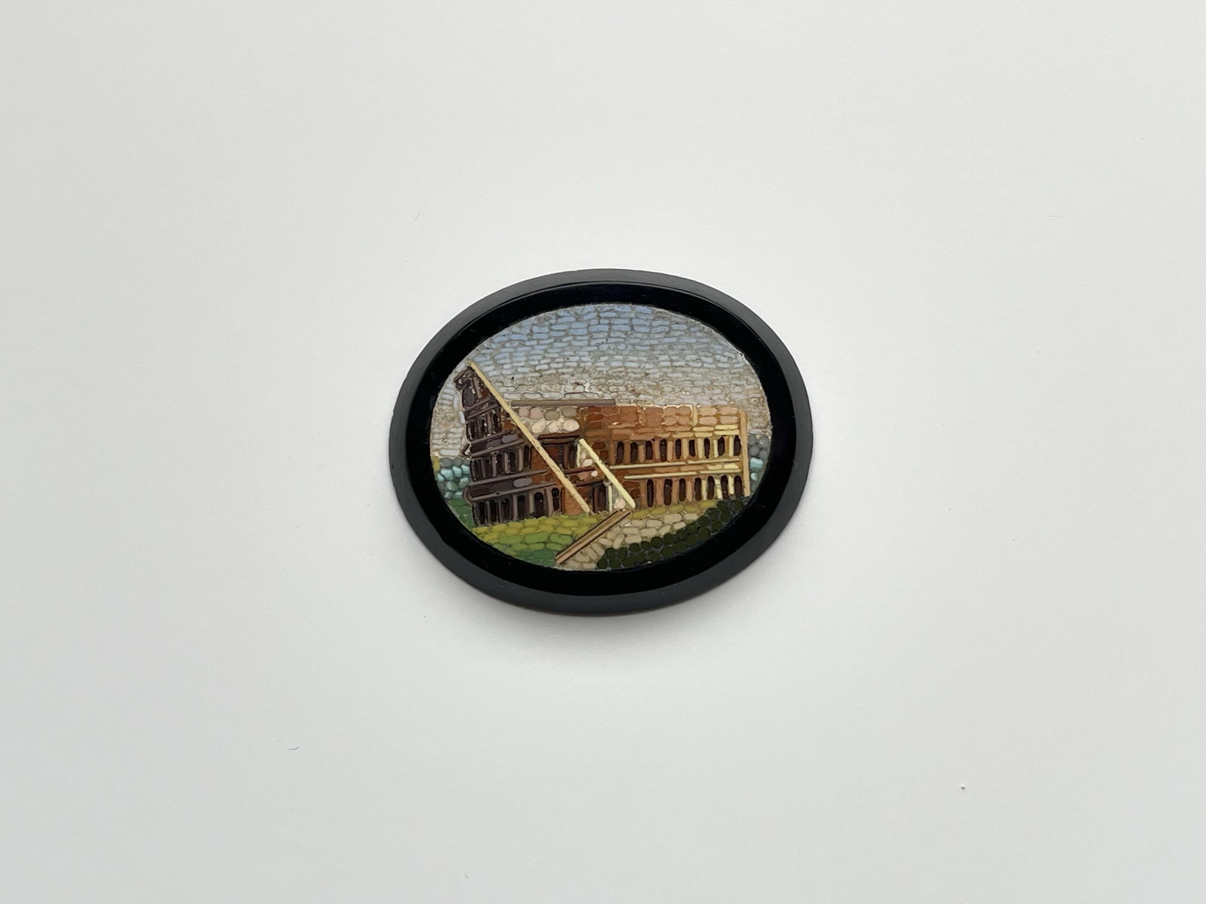Two wonderful 1800 circa Micro mosaic handmade by craftsmen and assembled with micro mosaic made in onyx depicting the colosseum of Rome.

Brooch total weight 27.80 grams circa