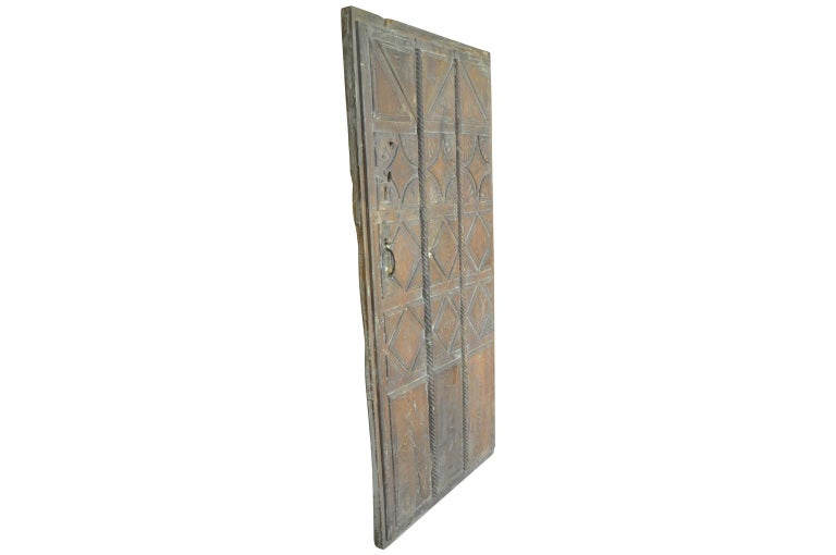 A very handsome mid-18th century entry door from Northern Italy. Wonderfully constructed from solid chestnut with stunning carving details and iron fittings. Perfect to incorporate into cabinetry or as a garden door. Fabulous patina.