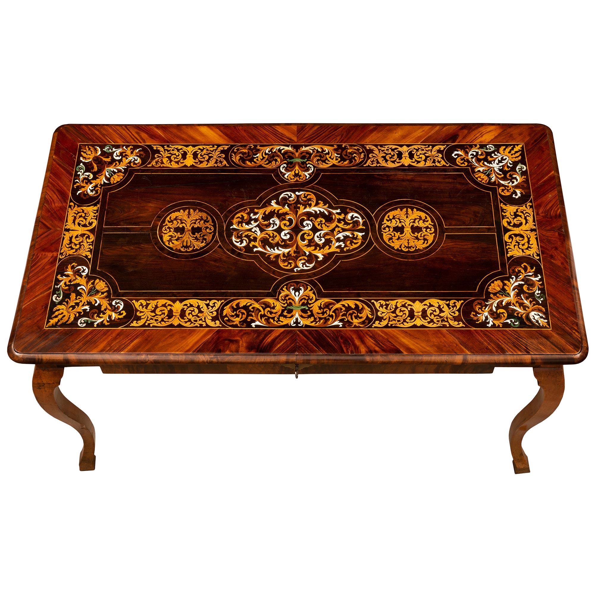 A spectacular and very high quality Italian mid 18th century Louis XV period Walnut, Rosewood, Charmwood and bone center table/desk circa 1740. This table from the Piedmont region is raised by elegant tapered legs with fine block feet and beautiful