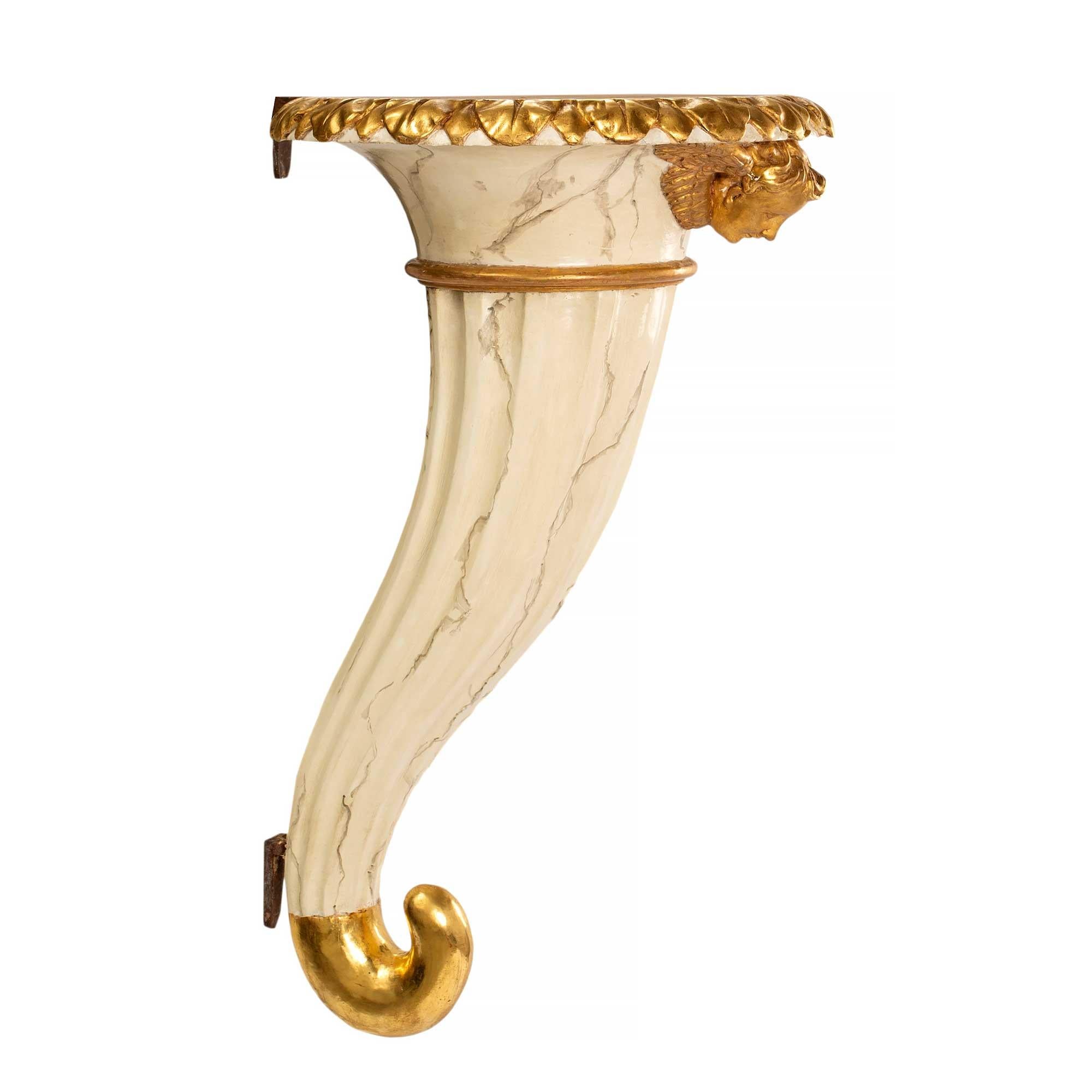 A sensation and unique pair of Italian mid 18th century Venetian faux marble and giltwood wall brackets. The pair are in the shape of a cornucopia with the bottom swirl in a beautiful burnished gilt finish. The center has a wonderful faux white