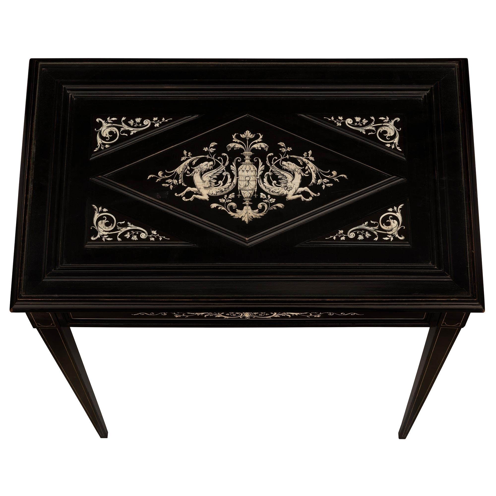 A charming and extremely elegant Italian 19th century Milanese st. ebonized Fruitwood and bone side table. The one drawer table is raised by delicate square tapered legs with fine inlaid bone fillets below rectangular bone inlaid block reserves. The