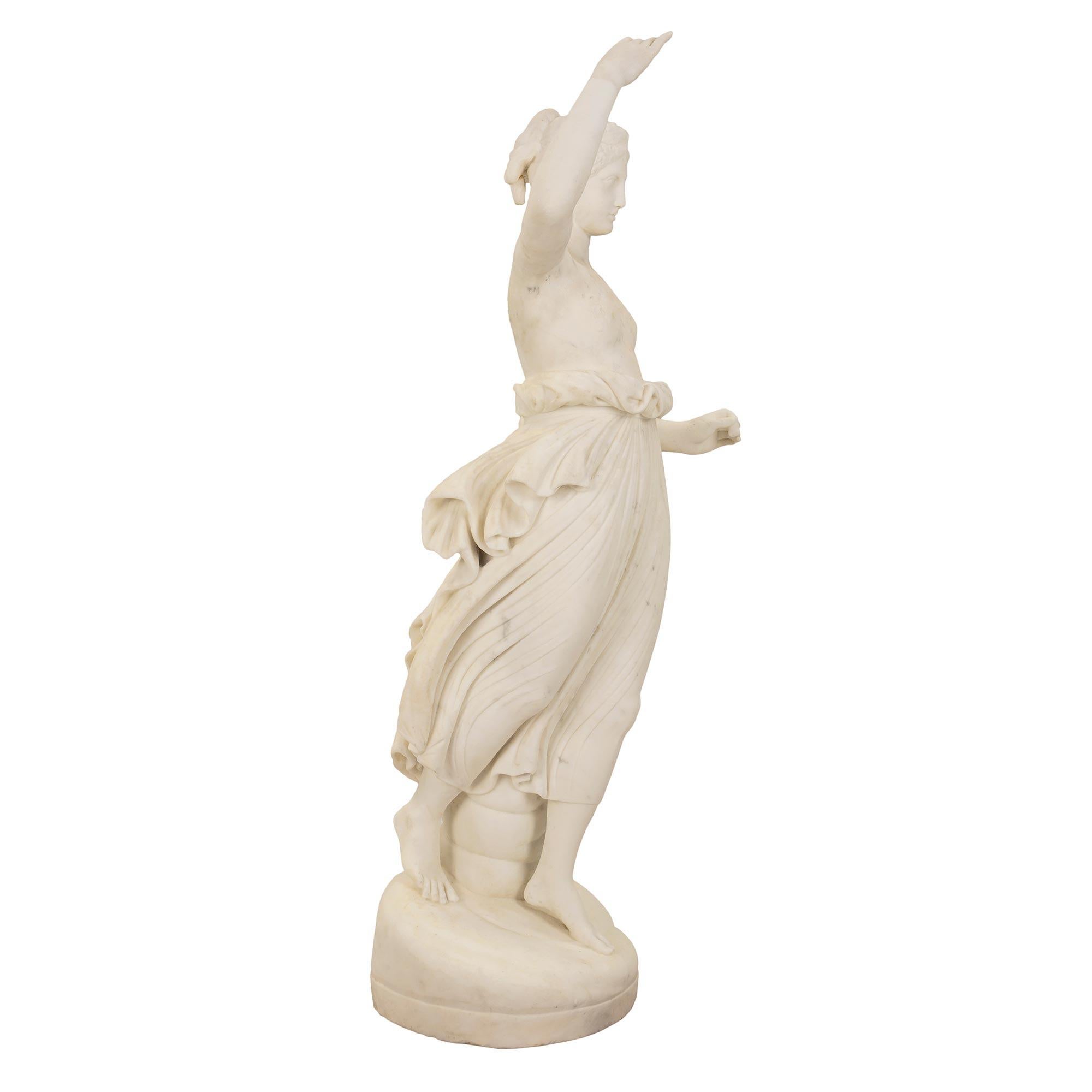 A very elegant Italian mid 19th century Neo-Classical st. white Carrara marble signed statue of Hebe, modeled after the original by Antonio Canova. Hebe stands on an oval shaped grotto base, dressed in classical drape tied at her waist. Both her