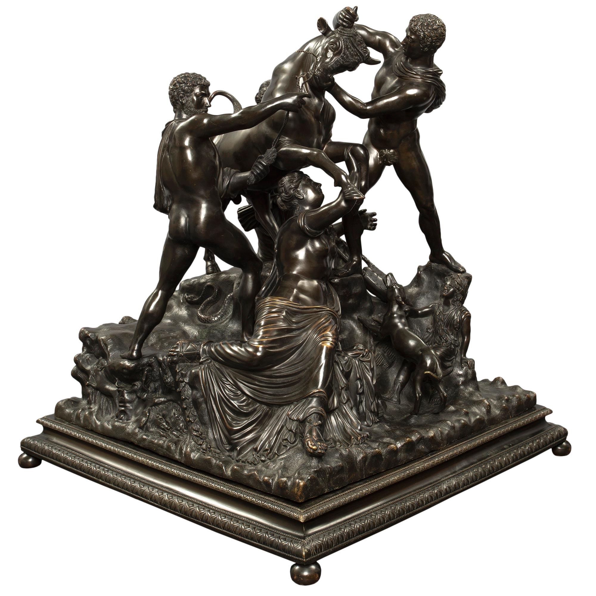 A most handsome and large scale Italian mid 19th century patinated bronze statue of the Farnese Bull. The rich and warmly patinated bronze is raised by a square mottled support with a palmette designed border all above ball feet. The sculptural