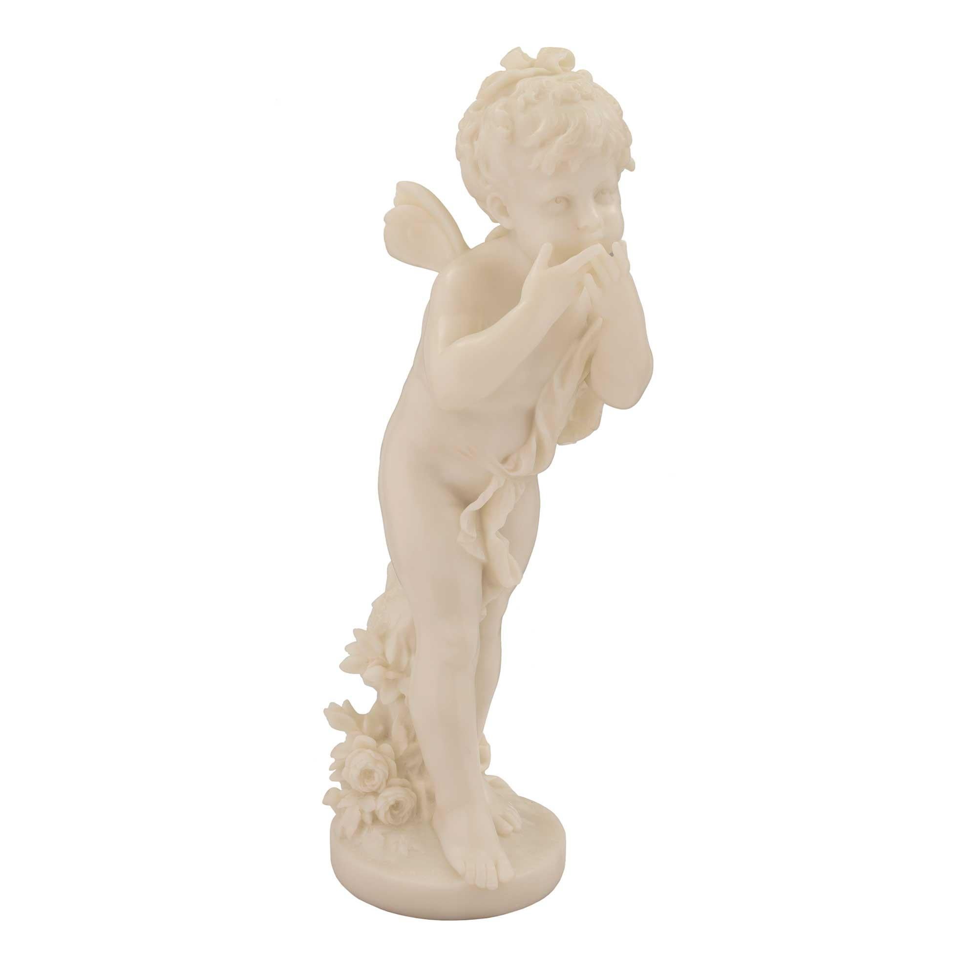 An absolutely charming and well executed Italian mid 19th century white Carrara marble statue of winged girl. The girl is standing above a circular base with a richly carved bouquet of flowers. She is holding up her arms to her face as if she was