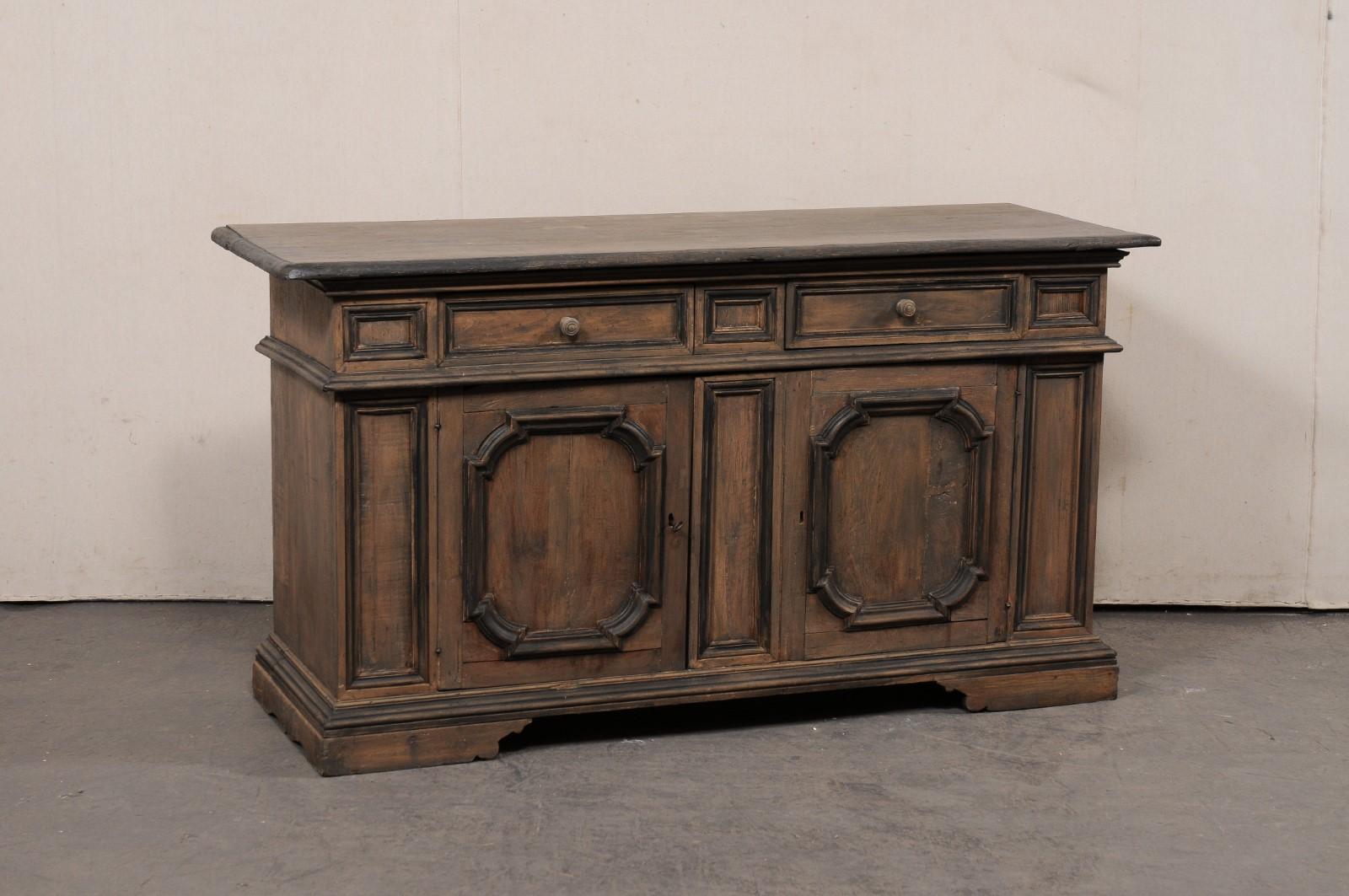 An Italian painted and carved wood buffet console from the mid 20th century. This vintage cabinet from Italy, just shy of 5.5 feet in length, features a rectangular-shaped top with beveled edging that overhangs the case which houses a pair of