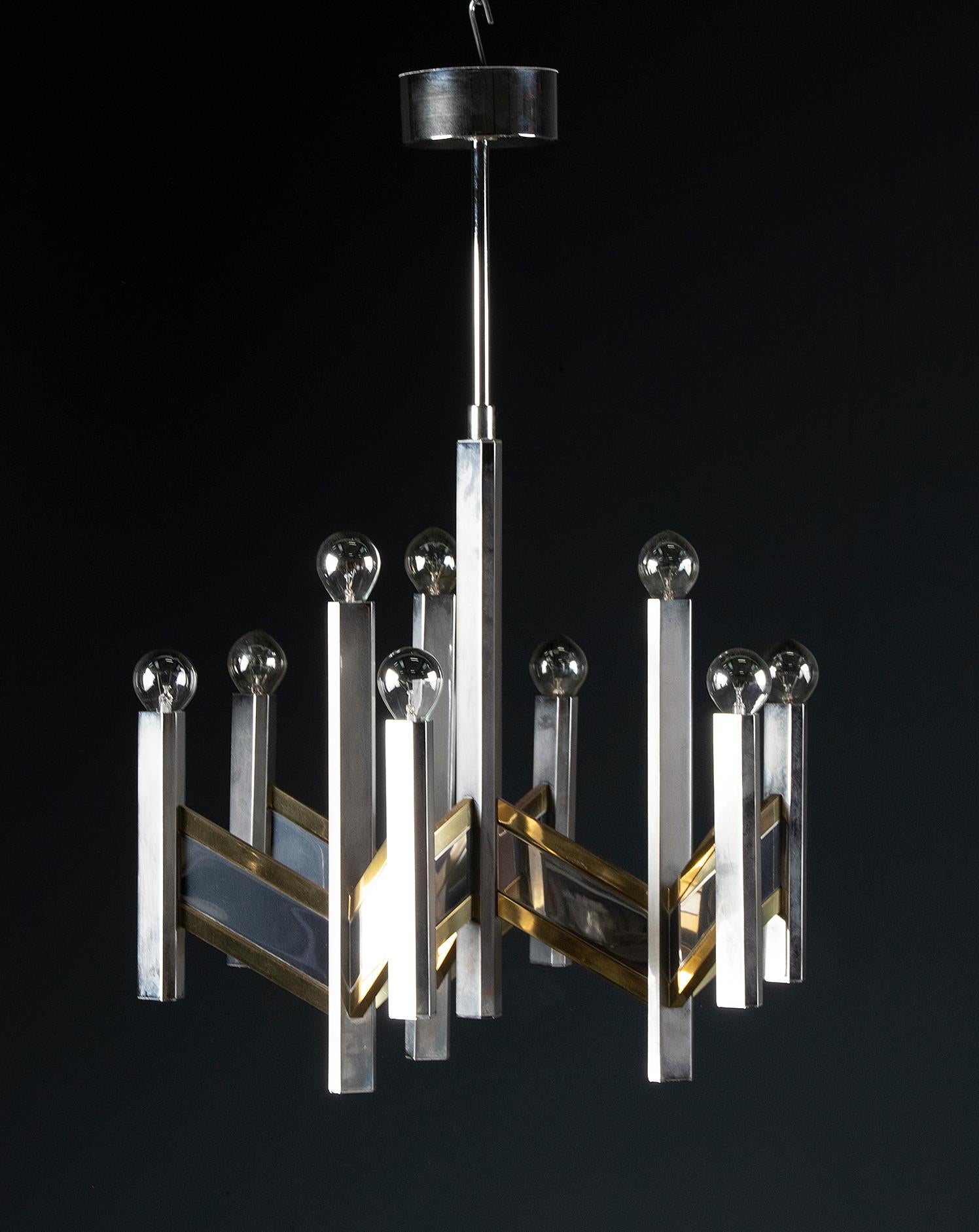 Beautiful vintage chandelier from the Italian brand Sciolari. The lamp has a special design with clean lines and many angles. The lamp is made of stainless steel and brass. The ceiling piece contains an original Sciolari label. The lamp has a total