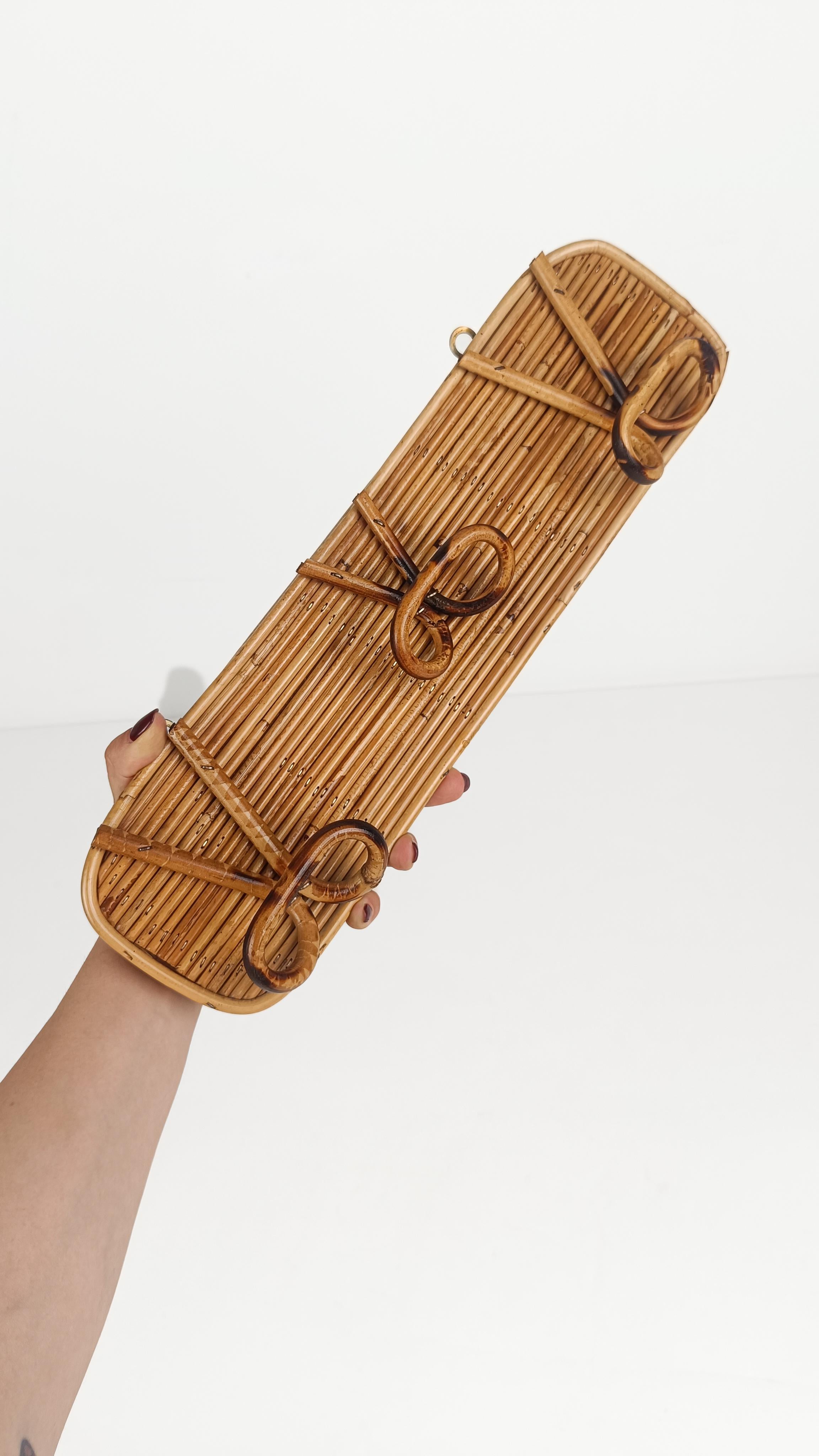 We offer for sale a mid-20th century wall coat anger made in Italy in the style of the well-known Roman company specializing in cane furnishings 