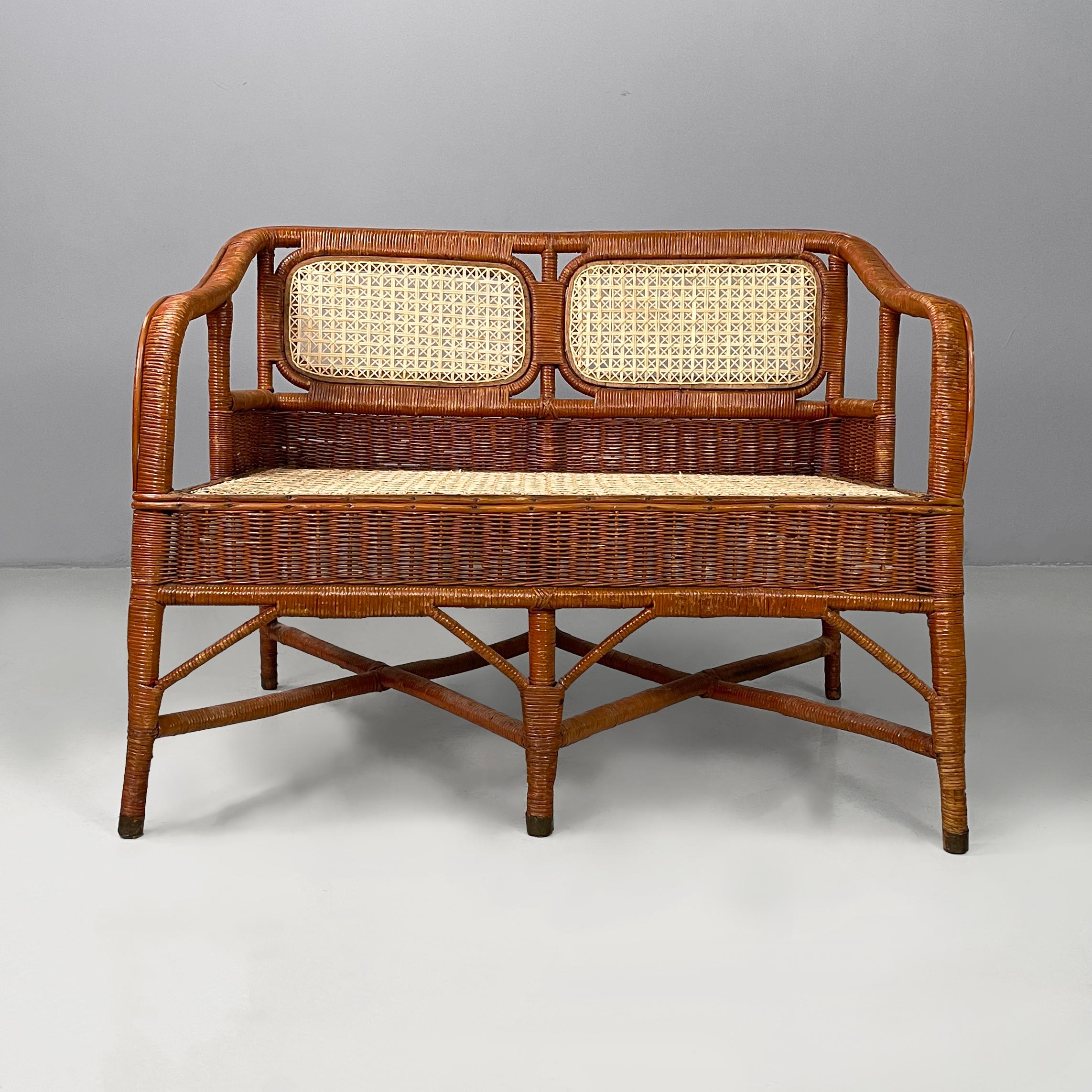 Italian Mid-centrury Modern Two-seater outdoor bench in woven rattan, 1960s
Two-seater outdoor bench entirely in woven rattan. The backrest is in rattan with white wicker weaves with a star pattern. Curved armrests. The seat has the same pattern and